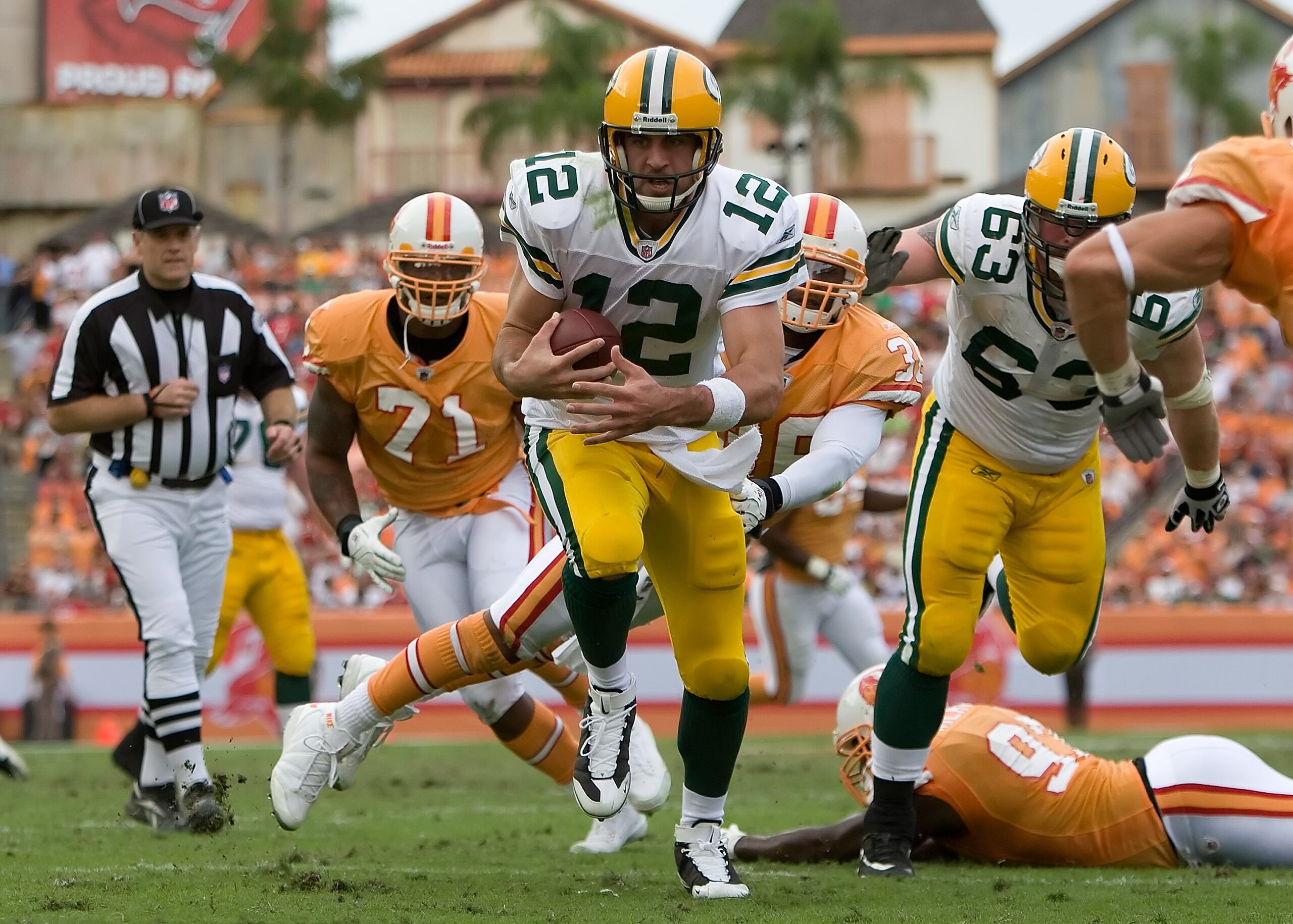TAMPA, FL - NOVEMBER 08:  Quarterback Aaron Rodgers #12 of the Green Bay Packers scores a fourth quarter touchdown as defenders Barrett Ruud #51 and Sabby Piscatelli #21 of the Tampa Bay Buccaneers deliver a hit during the game at Raymond James Stadium on