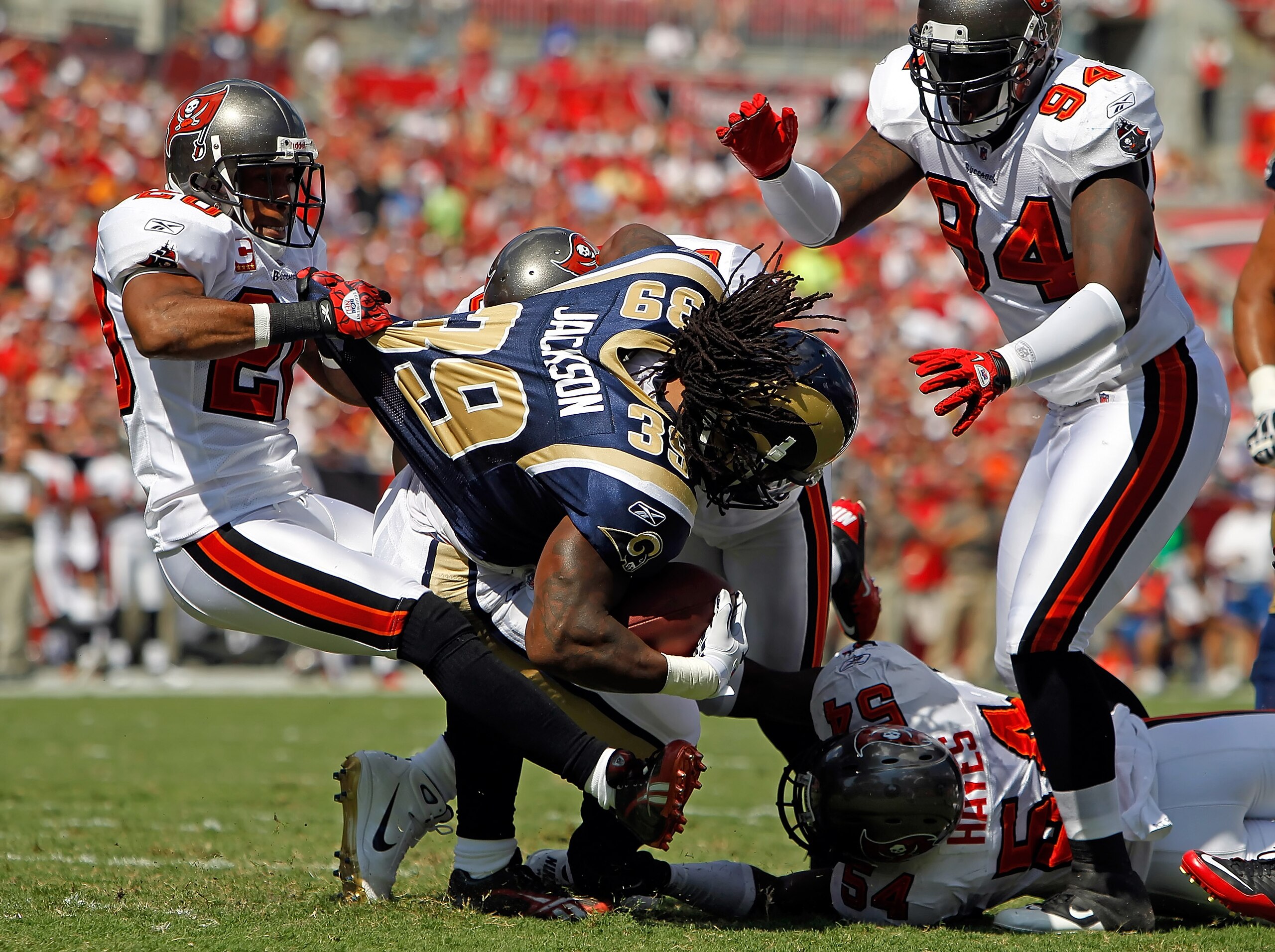 TAMPA, FL - OCTOBER 24:  Running back Steven Jackson #39 of the St. Louis Rams is tackled by defenders Ronde Barber #20, Sean Jones #26, Geno Hayes #54 and Kyle Moore #94 of the Tampa Bay Buccaneers during the game at Raymond James Stadium on October 24,