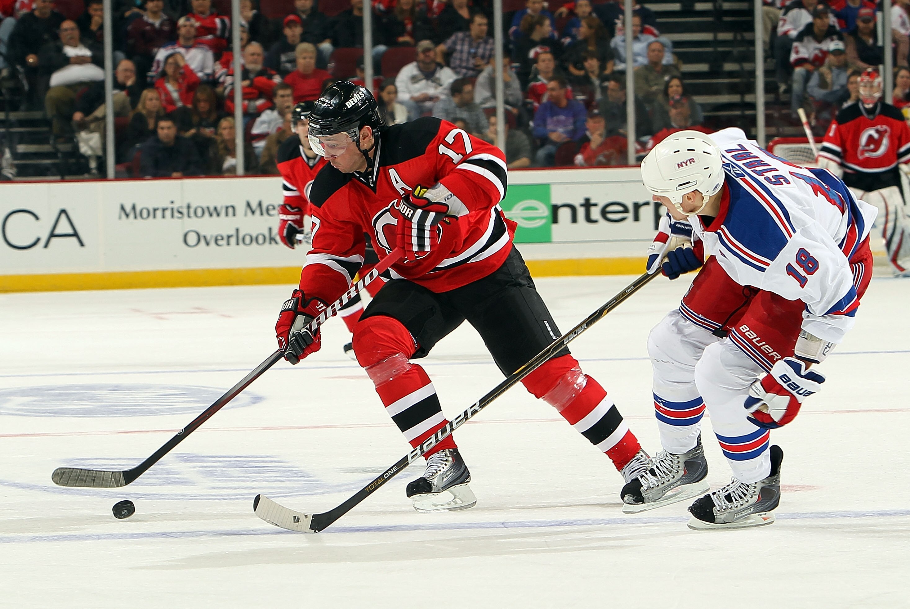 NEWARK, NJ - NOVEMBER 05: Ilya Kovalchuk #17 of the New Jersey Devils skates with the puck infront of Marc Staal #18 of the New York Rangers at the Prudential Center on November 5, 2010 in Newark, New Jersey.  (Photo by Nick Laham/Getty Images)