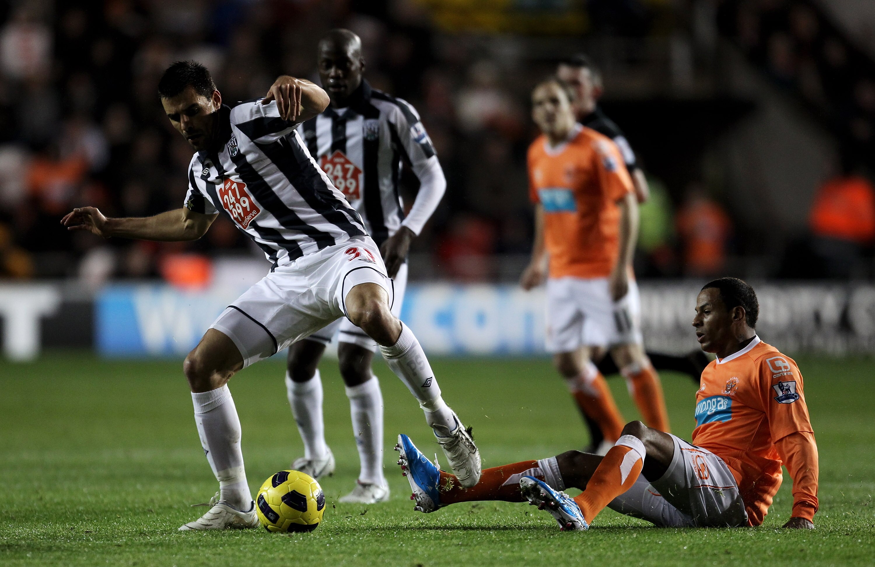 BLACKPOOL, ENGLAND - NOVEMBER 01:  Paul Scharner of West Bromwich Albion is tackled by DJ Campbell of Blackpool during the Barclays Premier League match between Blackpool and West Bromwich Albion at Bloomfield Road on November 1, 2010 in Blackpool, Englan