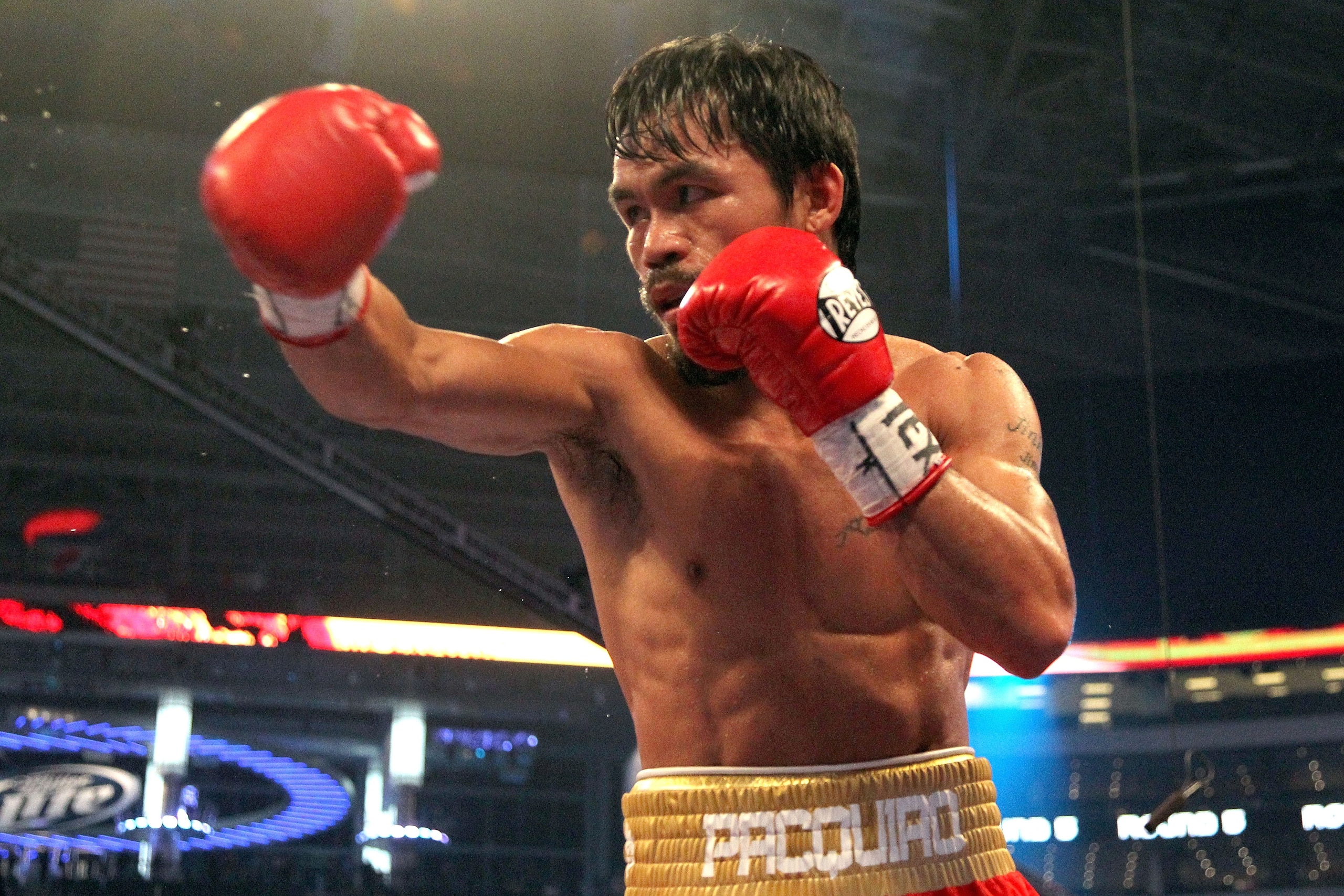 ARLINGTON, TX - MARCH 13: Manny Pacquiao of the Philippines throws a punch in the ring against Joshua Clottey of Ghana during the WBO welterweight title fight at Cowboys Stadium on March 13, 2010 in Arlington, Texas. Pacquiao defeated Clottey by unanimou ARLINGTON, TX - MARCH 13: Manny Pacquiao of the Philippines throws a punch in the ring against Joshua Clottey of Ghana during the WBO welterweight title fight at Cowboys Stadium on March 13, 2010 in Arlington, Texas. Pacquiao defeated Clottey by unanimou