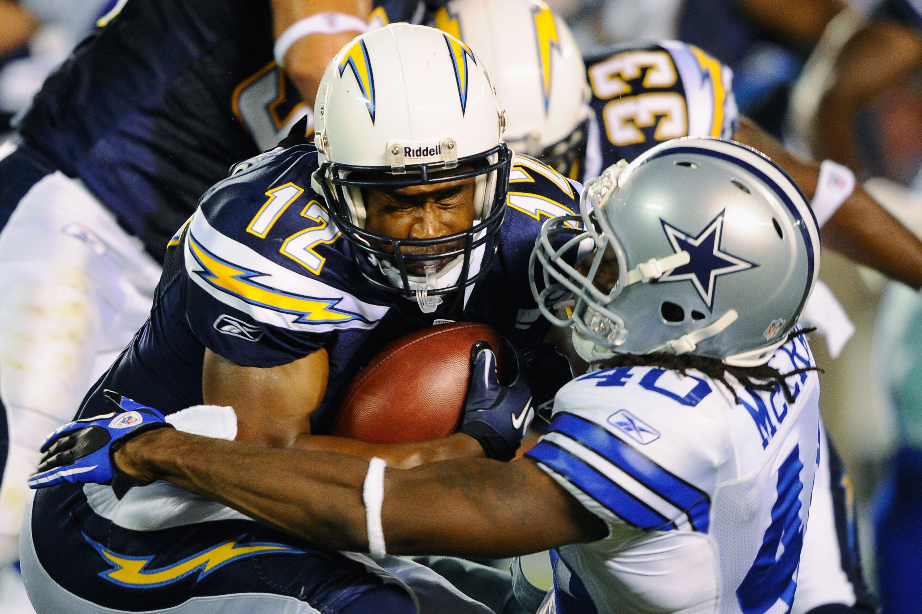 SAN DIEGO - AUGUST 21:  Wide receiver Gary Banks #12 of the San Diego Chargers gets a hit from Danny McCray #40 of Dallas Cowboys during the pre-season NFL football game against at Qualcomm Stadium on August 21, 2010 in San Diego, California.  (Photo by K