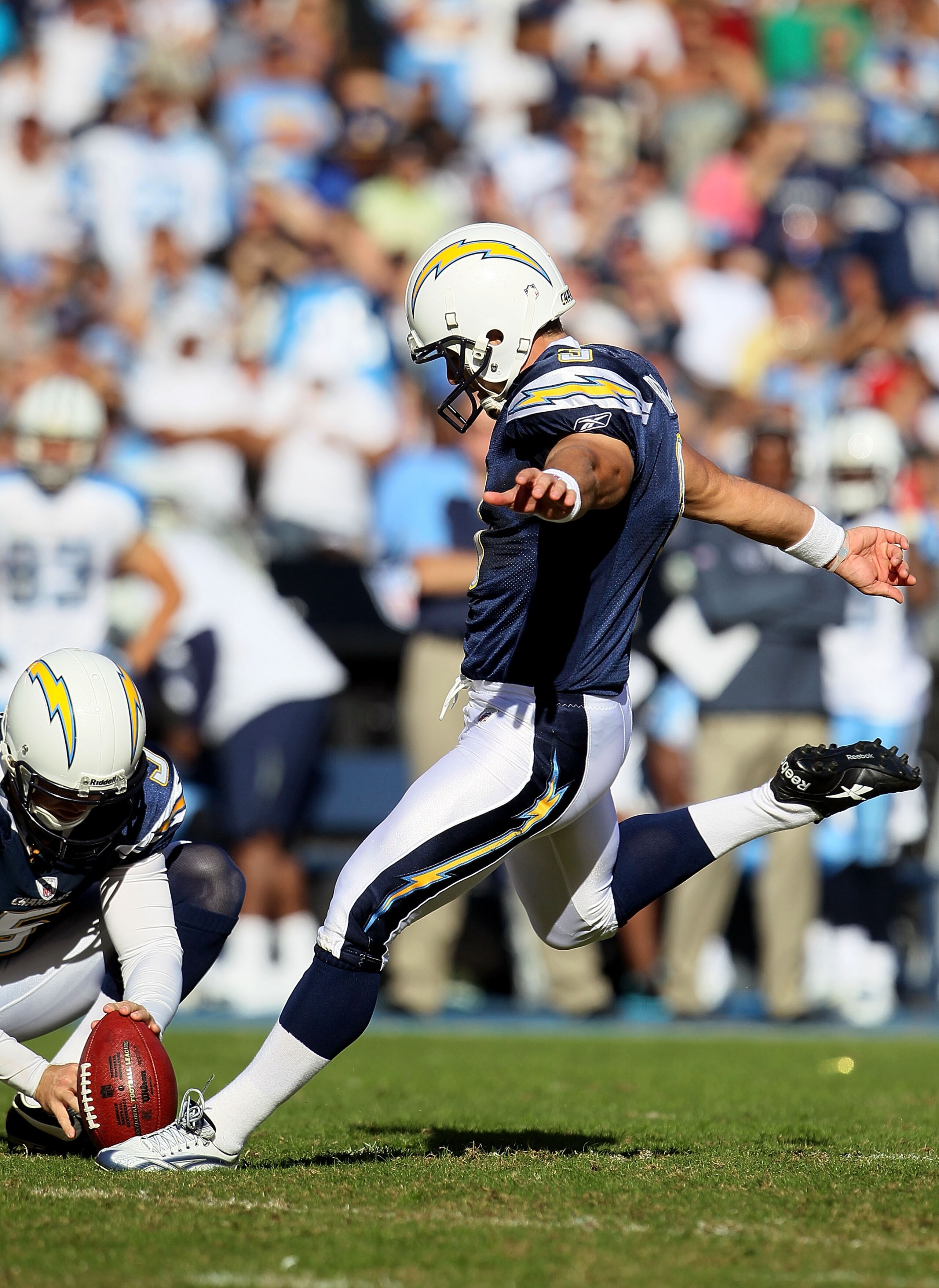 SAN DIEGO - OCTOBER 31:  Kris Brown #3 of the San Diego Chargers kicks as punter Mike Scrifes #5 holds the ball during the game against the Tennessee Titans in the game at Qualcomm Stadium on October 31, 2010 in San Diego, California. The Chargers defeate