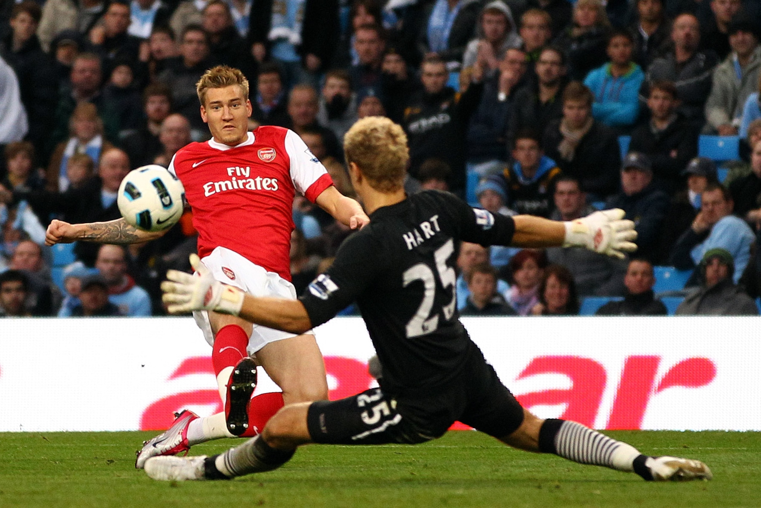 MANCHESTER, ENGLAND - OCTOBER 24:  Nicklas Bendtner of Arsenal scores the third goal past Joe Hart of City during the Barclays Premier League match between Manchester City and Arsenal at City of Manchester Stadium on October 24, 2010 in Manchester, Englan