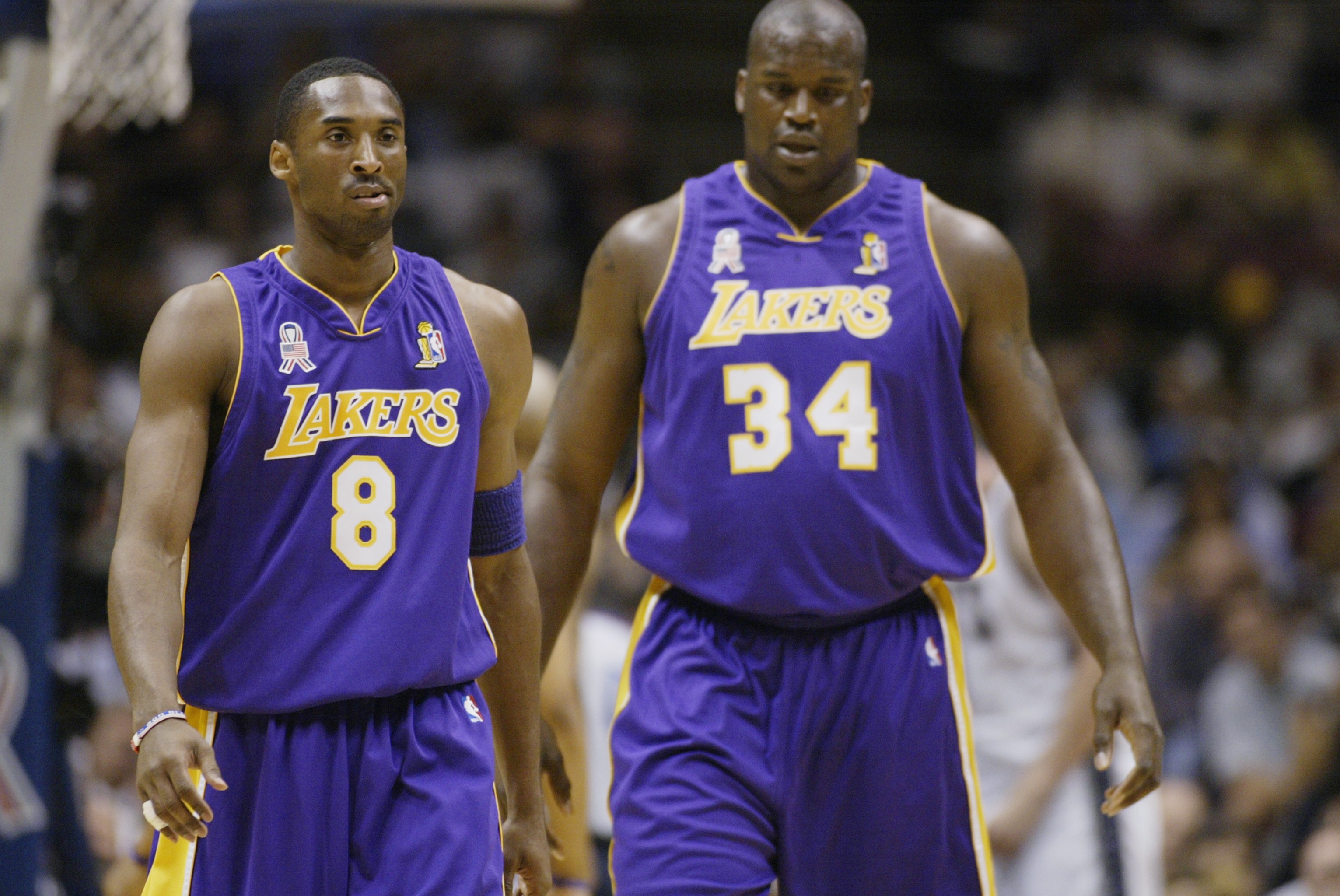 EAST RUTHERFORD, NJ - JUNE 12:  Kobe Bryant #8 and Shaquille O'Neal #34 of the Los Angeles Lakers walk upcourt in Game four of the 2002 NBA Finals against the New Jersey Nets on June 12, 2002 at Continental Airlines Arena in East Rutherford, New Jersey. T