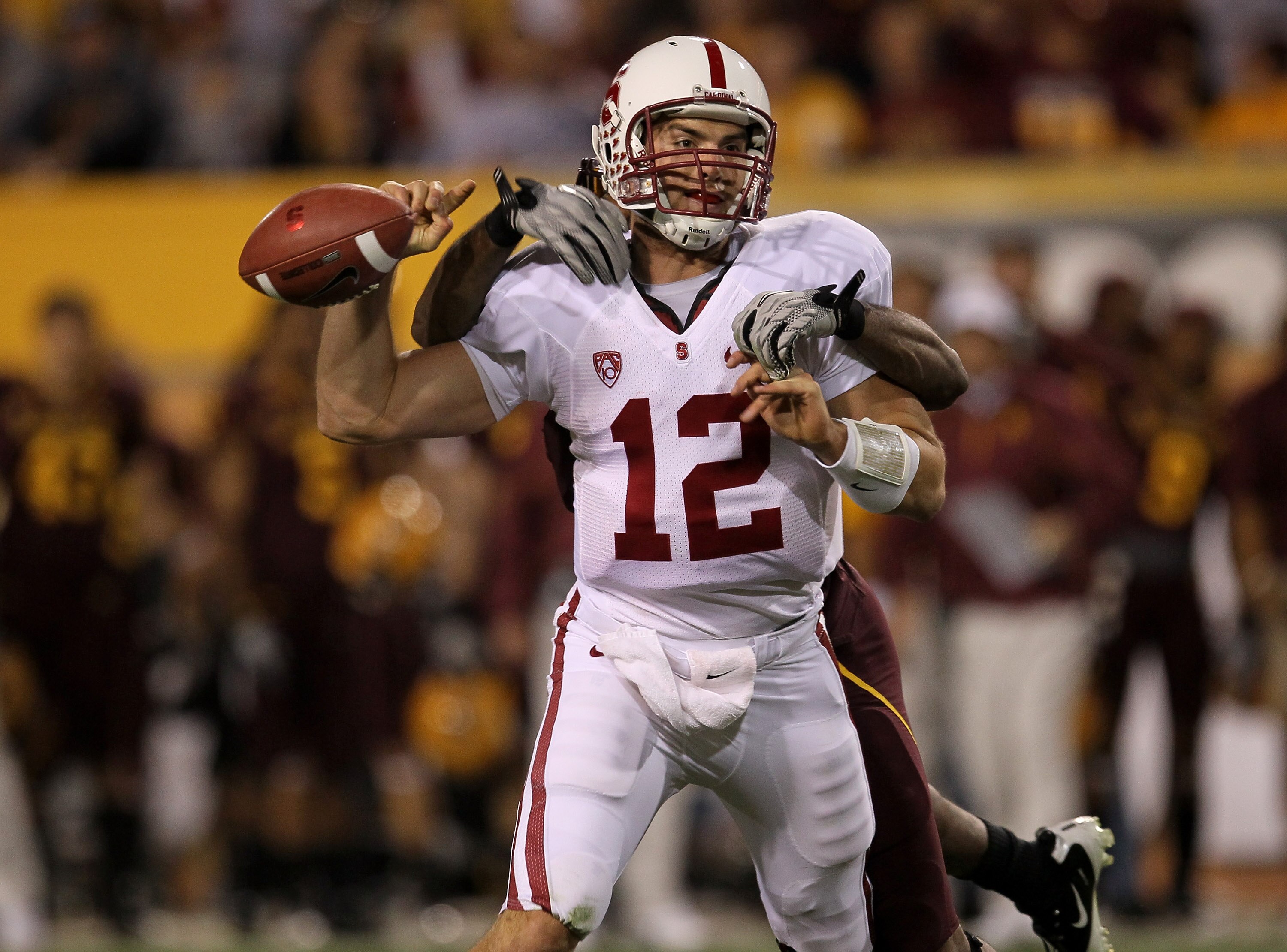 TEMPE, AZ - NOVEMBER 13:  Quarterback Andrew Luck #12 of the Stanford Cardinal fumbles away the ball as he is tackled by linebacker Oliver Aaron #18 of the Arizona State Sun Devils  at Sun Devil Stadium on November 13, 2010 in Tempe, Arizona.  (Photo by S