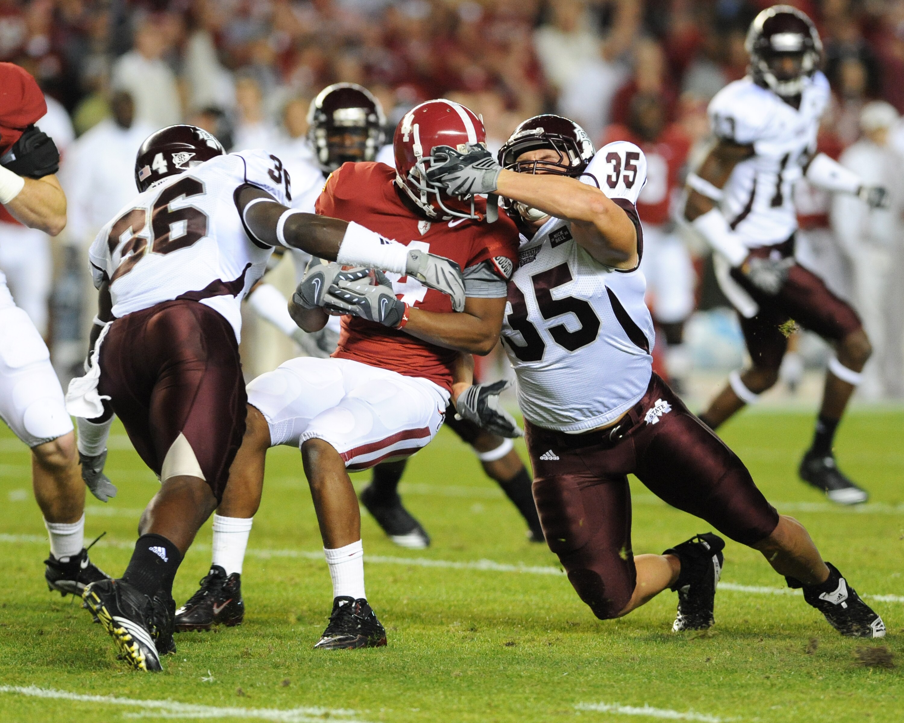 TUSCALOOSA, AL - NOVEMBER 13: Wide receiver Marquis Maze #4  of the Alabama Crimson Tide returns a kick and is tackled by Nick Bell #36 and Patrick Hanrahan #35 of the Mississippi State Bulldogs November 13, 2010 at Bryant-Denny Stadium in Tuscaloosa, Ala