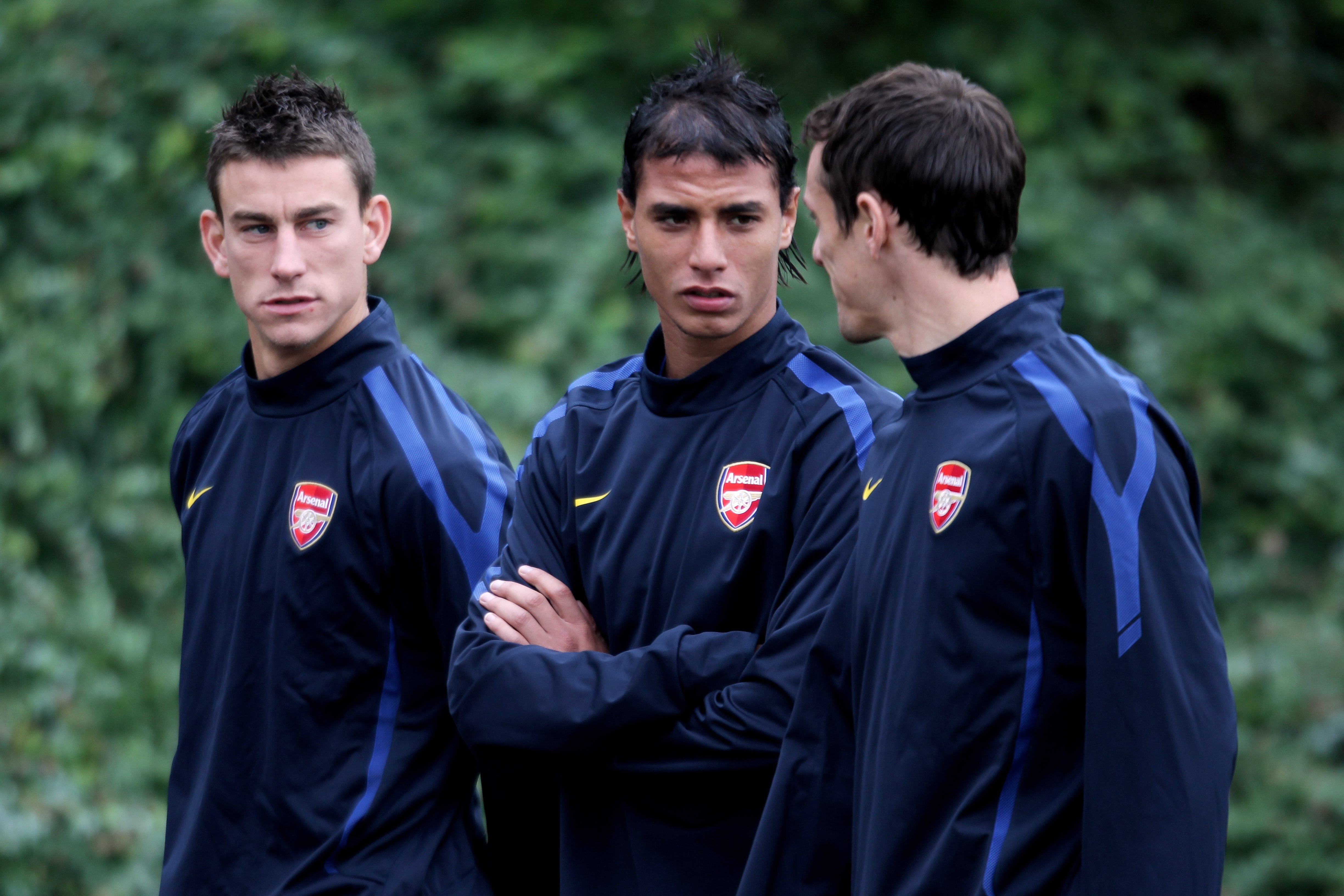 ST ALBANS, ENGLAND - SEPTEMBER 27:  (L-R)  Laurent Koscielny, Marouane Chamakh and Sebastien Squillaci speak prior to the training session ahead of the UEFA Champions League game against Partizan Belgrade at the club's complex at London Colney on Septembe