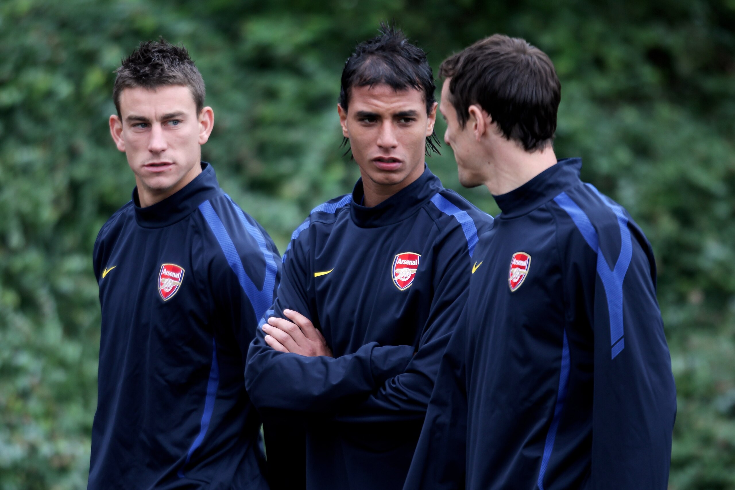 ST ALBANS, ENGLAND - SEPTEMBER 27:  (L-R)  Laurent Koscielny, Marouane Chamakh and Sebastien Squillaci speak prior to the training session ahead of the UEFA Champions League game against Partizan Belgrade at the club's complex at London Colney on Septembe