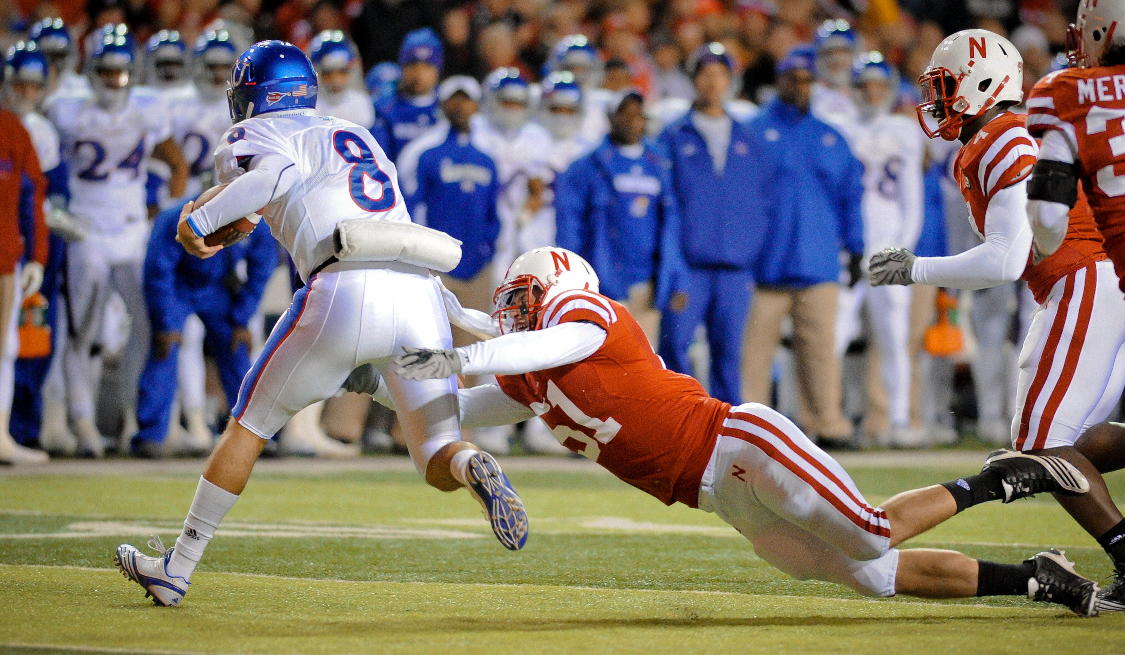 LINCOLN, NE - NOVEMBER 13: Quinn Mecham #8 of the Kansas Jayhawks is brought down by Will Compton #51 of the Nebraska Cornhuskers during first half action of their game at Memorial Stadium on November 13, 2010 in Lincoln, Nebraska. Nebraska  (Photo by Eri