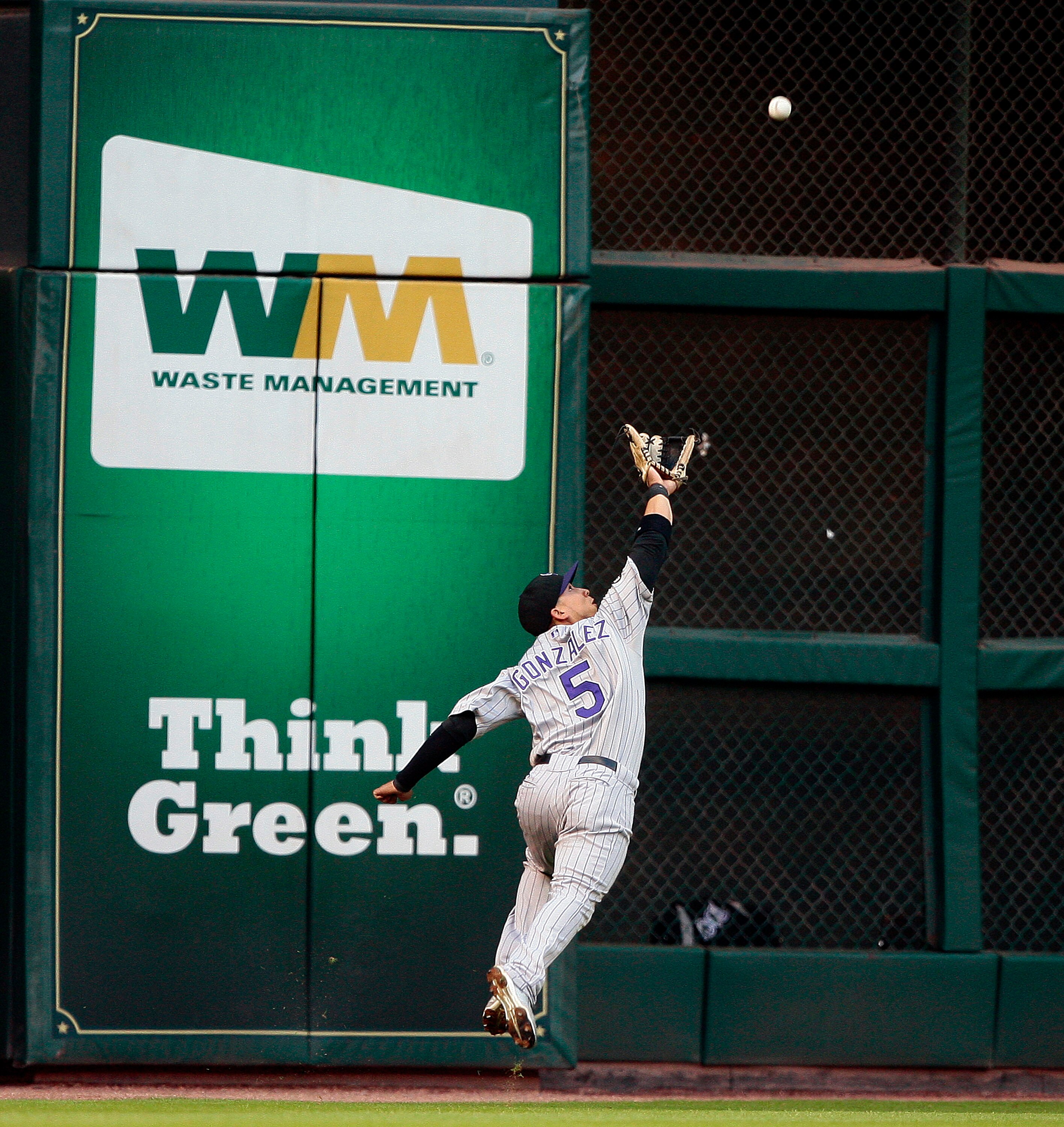 HOUSTON - MAY 19:  Left fielder Carlos Gonzalez #5 of the Colorado Rockies can't reach a hard hit ball by Tommy Manzella of the Houston Astros at Minute Maid Park on May 19, 2010 in Houston, Texas.  (Photo by Bob Levey/Getty Images)