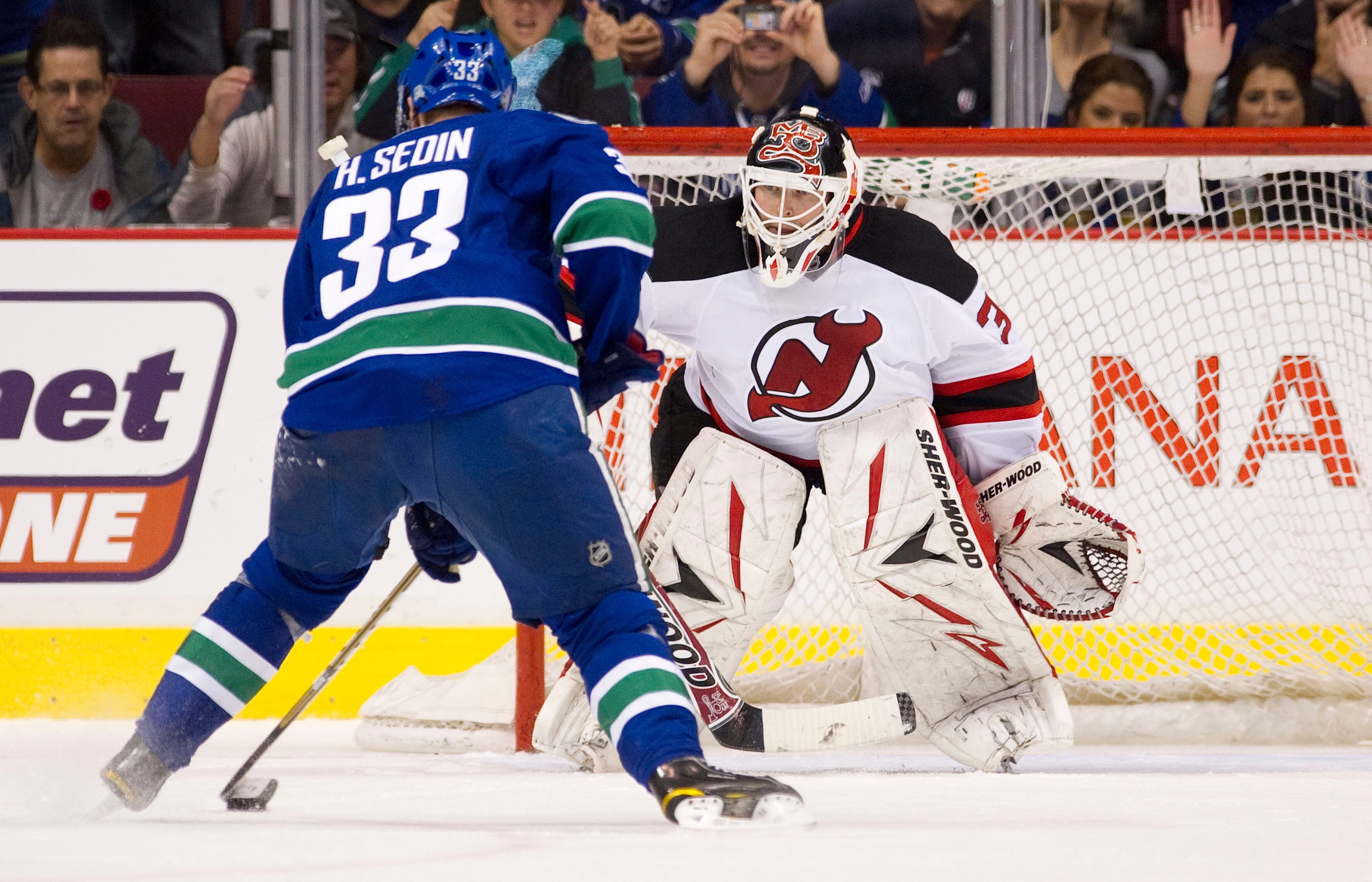 VANCOUVER, CANADA - NOVEMBER 1: Henrik Sedin #33 of the Vancouver Canucks puts a move on goalie Martin Brodeur #30 of the New Jersey Devils while taking a penalty shot during the third period in NHL action on November 01, 2010 at Rogers Arena in Vancouver