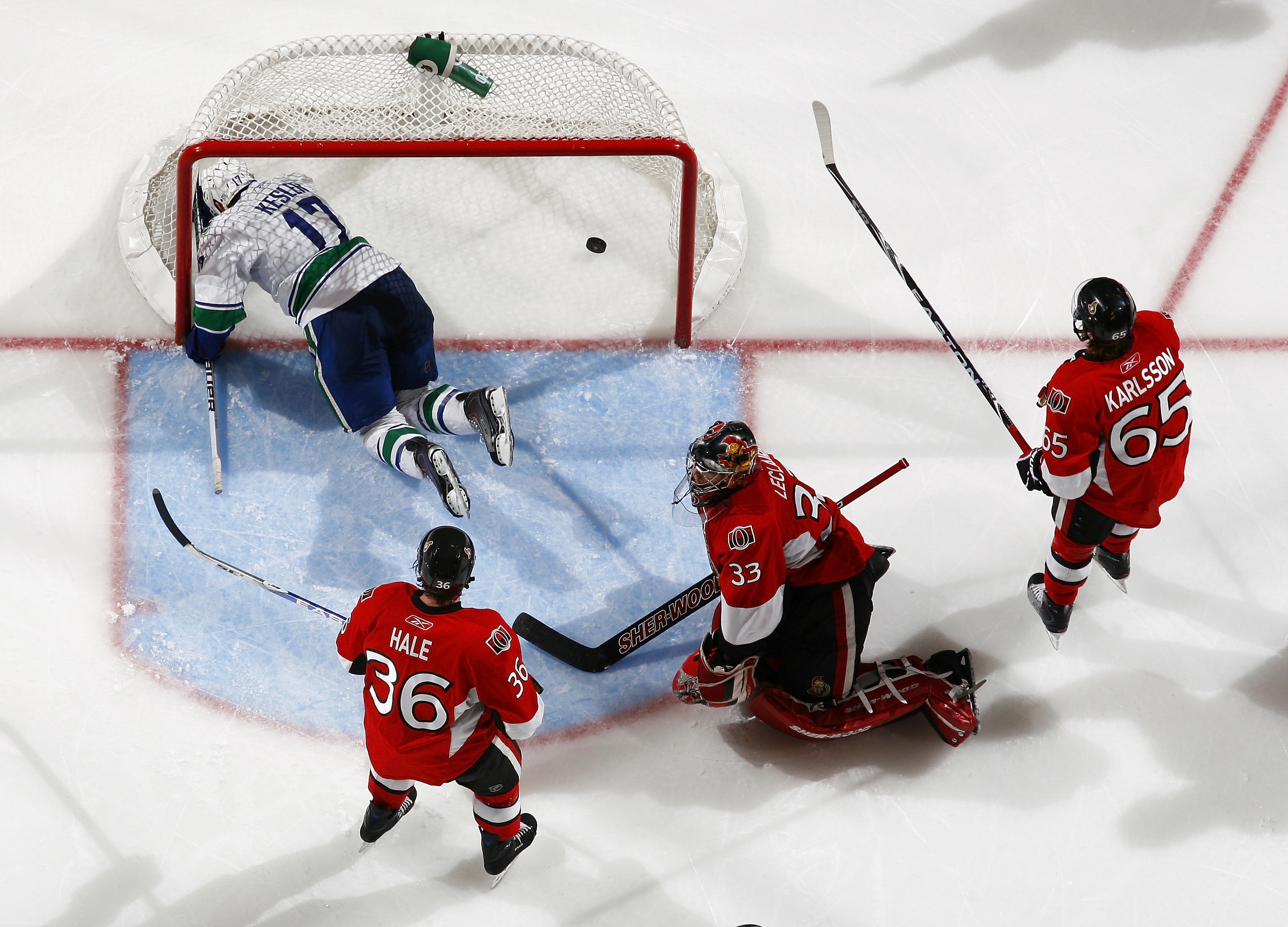 OTTAWA - NOVEMBER 11:  Ryan Kesler #17 of the Vancouver Canucks is knocked down in the net after scoring a goal while David Hale #36, Pascal Leclaire #33 and Erik Karlsson #65 of the Ottawa Senators look on during a game at Scotiabank Place on November 11