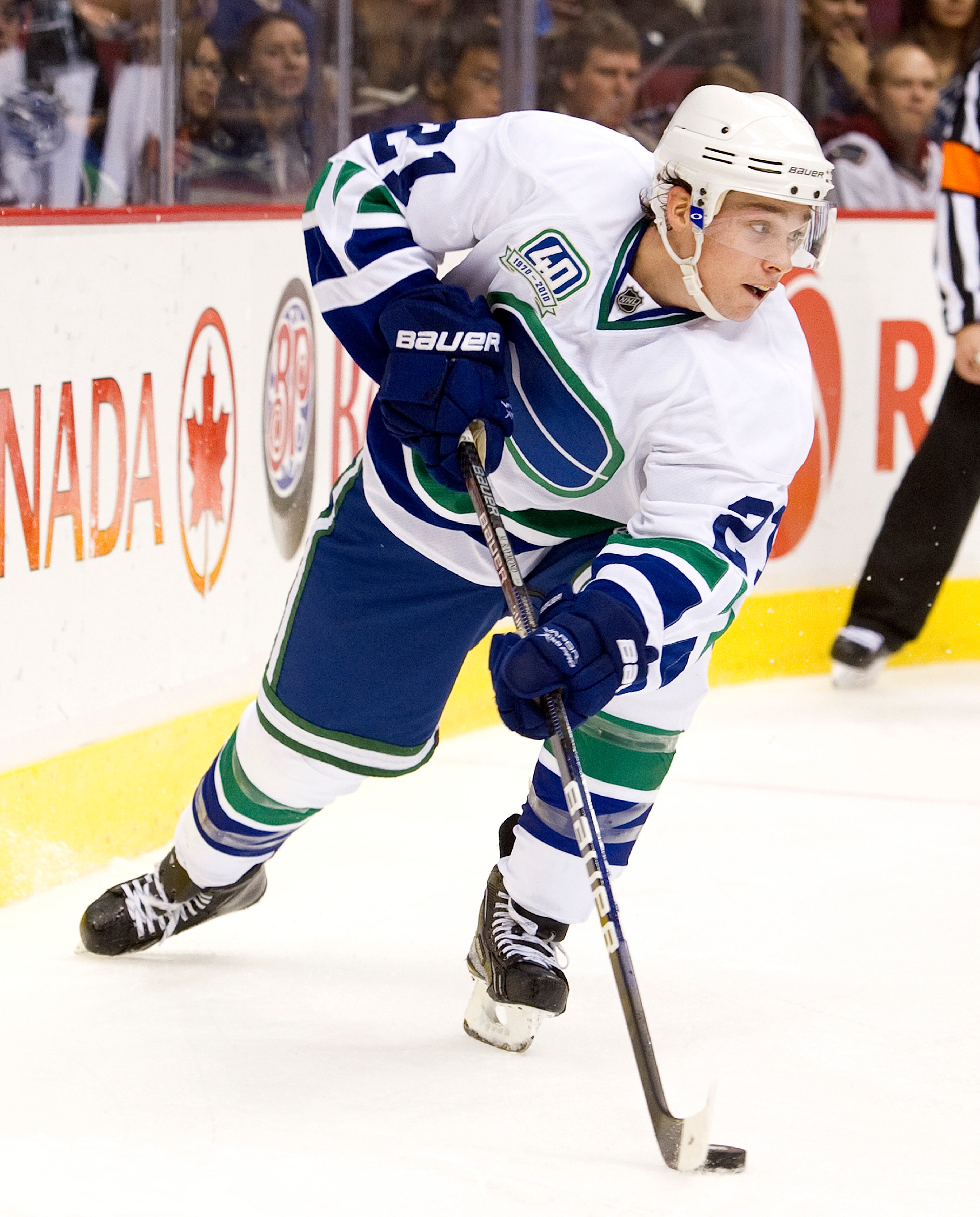 VANCOUVER, CANADA - OCTOBER 26: Mason Raymond #21 of the Vancouver Canucks carries the puck behind the net during NHL action against the Colorado Avalanche on October 26, 2010 at Rogers Arena in Vancouver, British Columbia, Canada.  (Photo by Rich Lam/Get