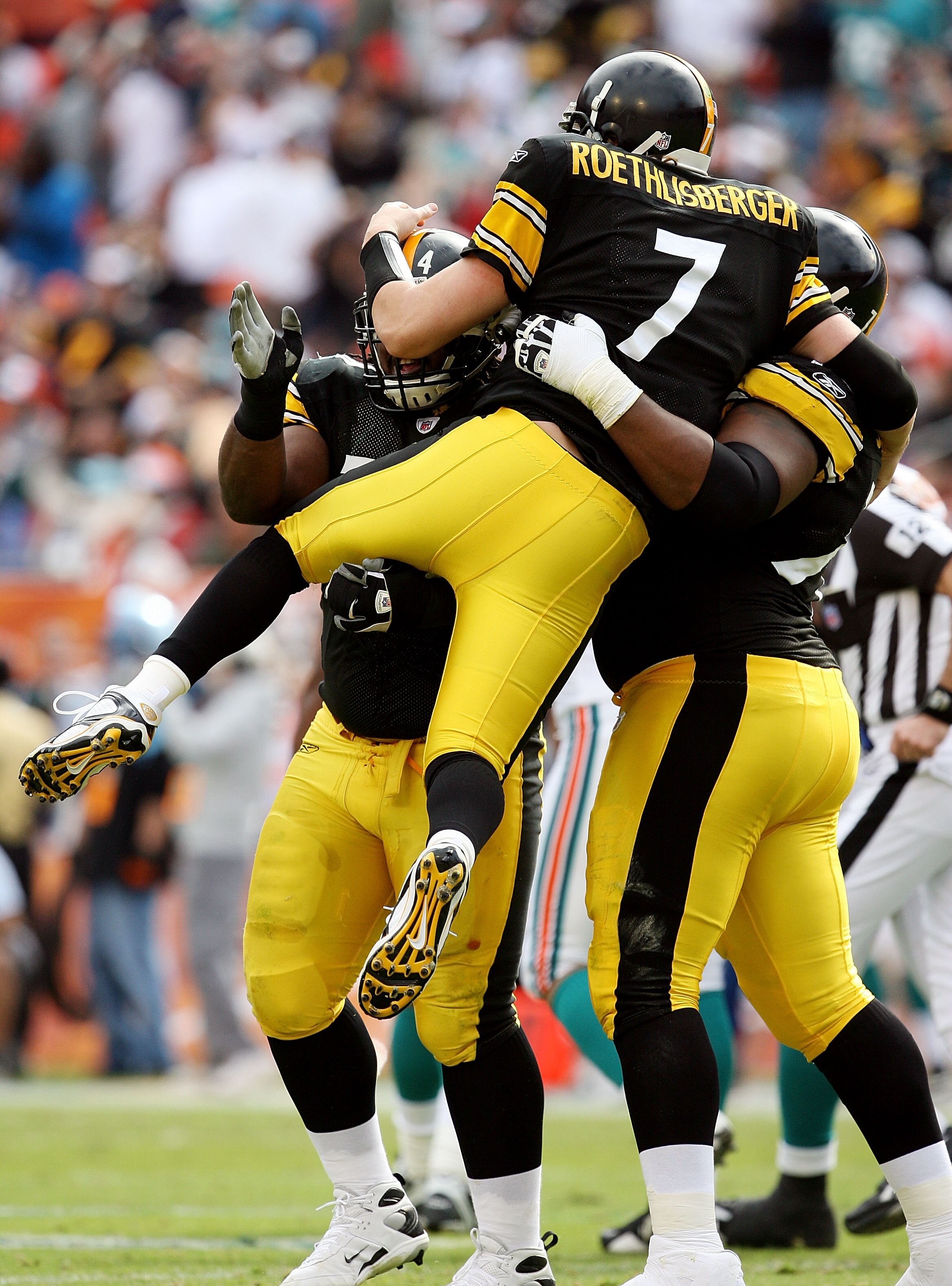 MIAMI - JANUARY 03:  Quarterback Ben Roethlisberger #7 of the Pittsburgh Steelers is lifted into the air by offensive linemen Max Starks #78 and Willie Colon #74 after Roethlisberger's touchdown pass to wide receiver Miike Wallace #17 in the second quarte
