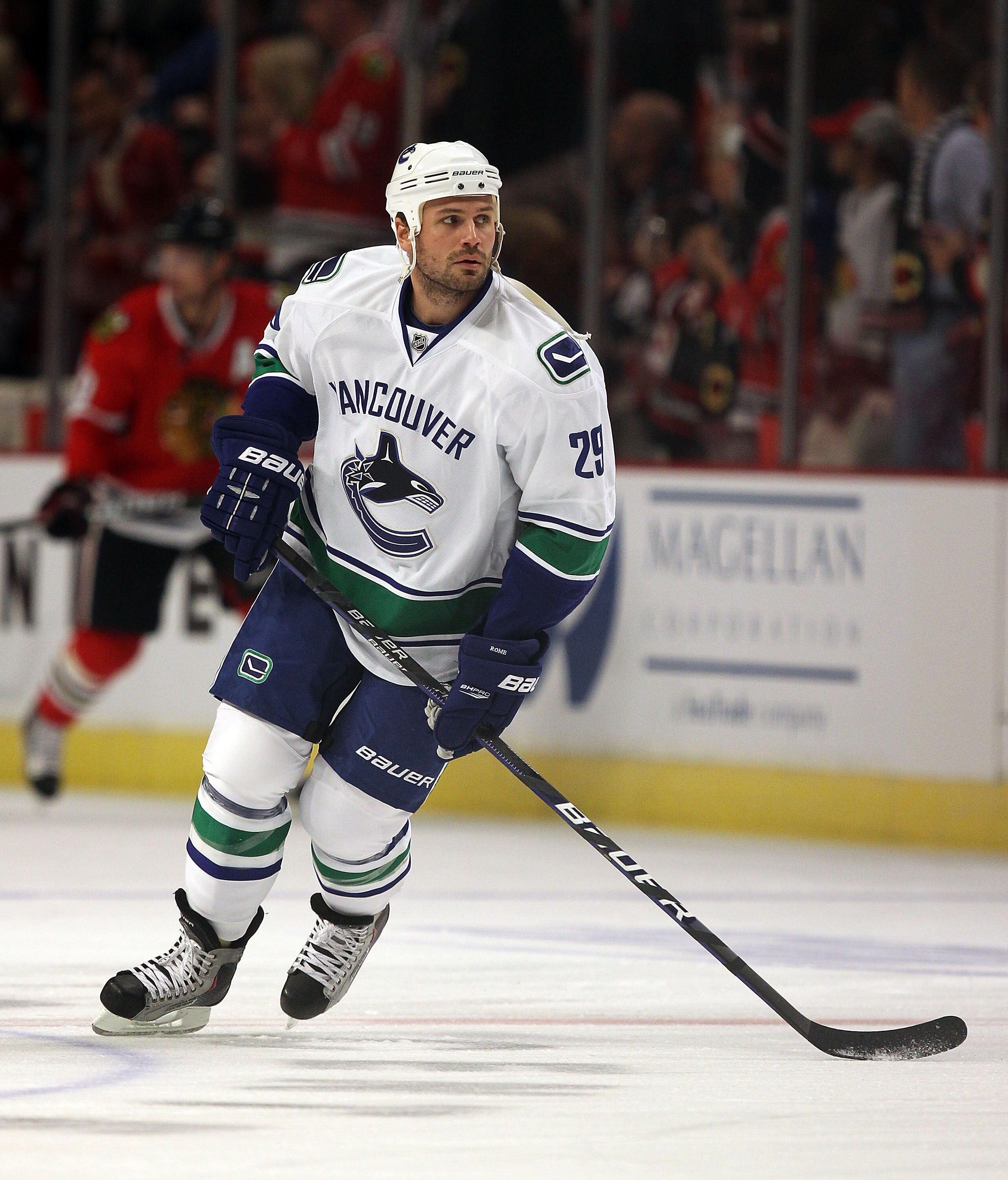 CHICAGO - OCTOBER 20: Aaron Rome #29 of the Vancouver Canucks participates in warm-ups before a game against the Chicago Blackhawks at the United Center on October 20, 2010 in Chicago, Illinois. The Blackhawks defeated the Canucks 2-1 in overtime.  (Photo