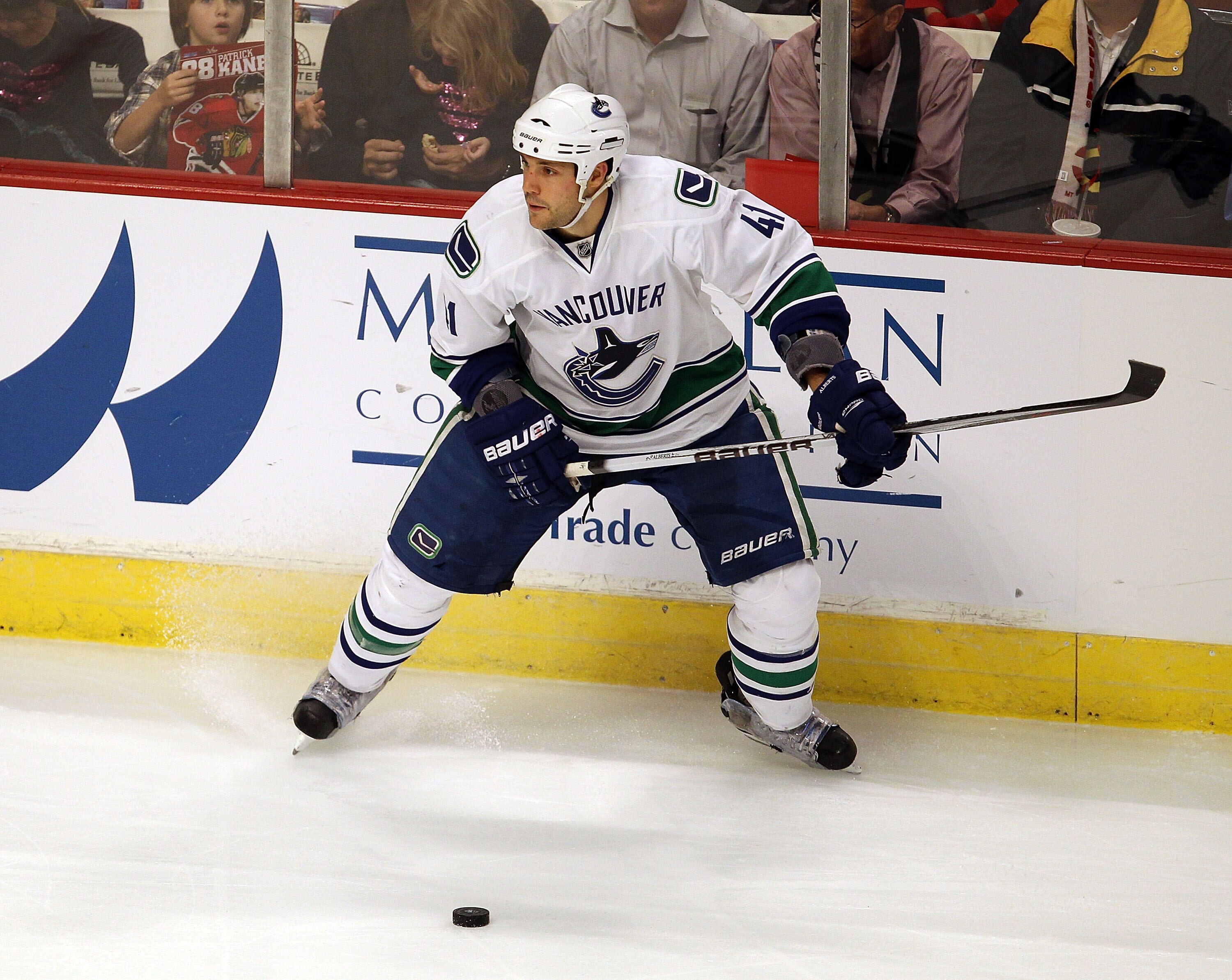 CHICAGO - OCTOBER 20: Andrew Alberts #41 of the Vancouver Canucks looks to pass the puck against the Chicago Blackhawks at the United Center on October 20, 2010 in Chicago, Illinois. The Blackhawks defeated the Canucks 2-1 in a shootout. (Photo by Jonatha