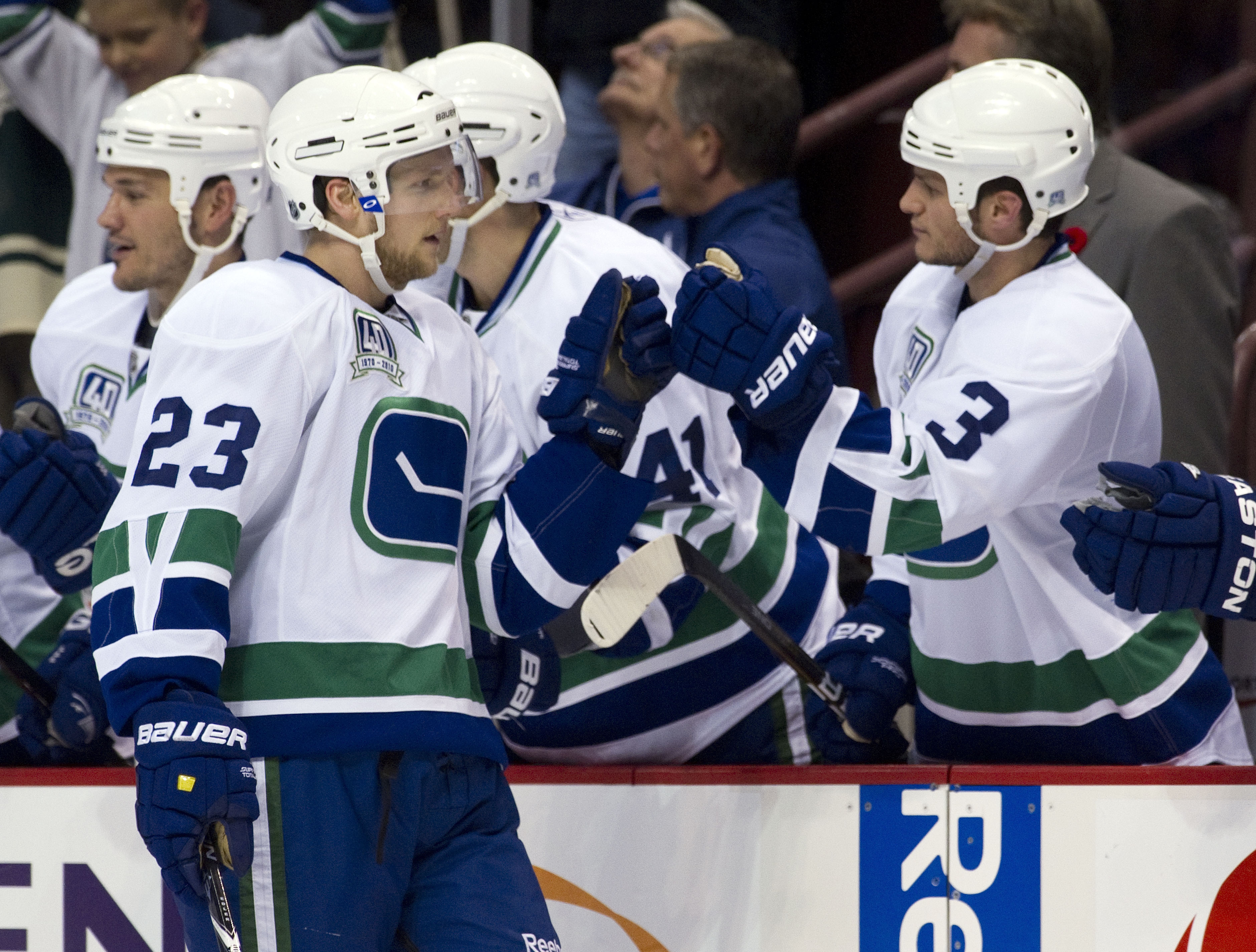 VANCOUVER, CANADA - NOVEMBER 6: Alexander Edler #23 of the Vancouver Canucks is congratulated by teammate Kevin Bieksa #3 after scoring what proved to be the game winning goal against the Detroit Red Wings during the third period in NHL action on November