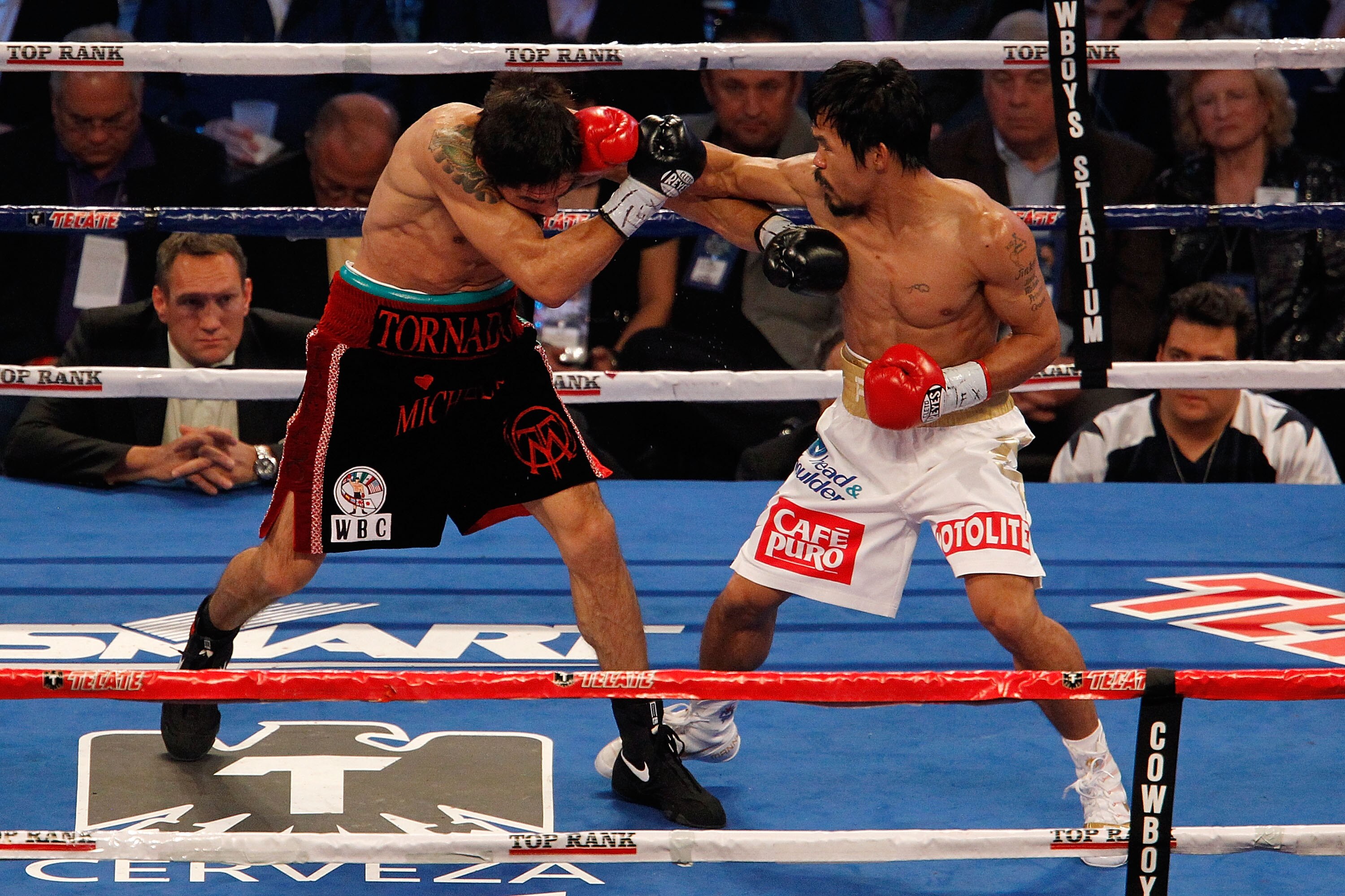 ARLINGTON, TX - NOVEMBER 13:  Manny Pacquiao (white trunks) of the Philippines lands a punch against Antonio Margarito (black trunks) of Mexico during their WBC World Super Welterweight Title bout at Cowboys Stadium on November 13, 2010 in Arlington, Texa