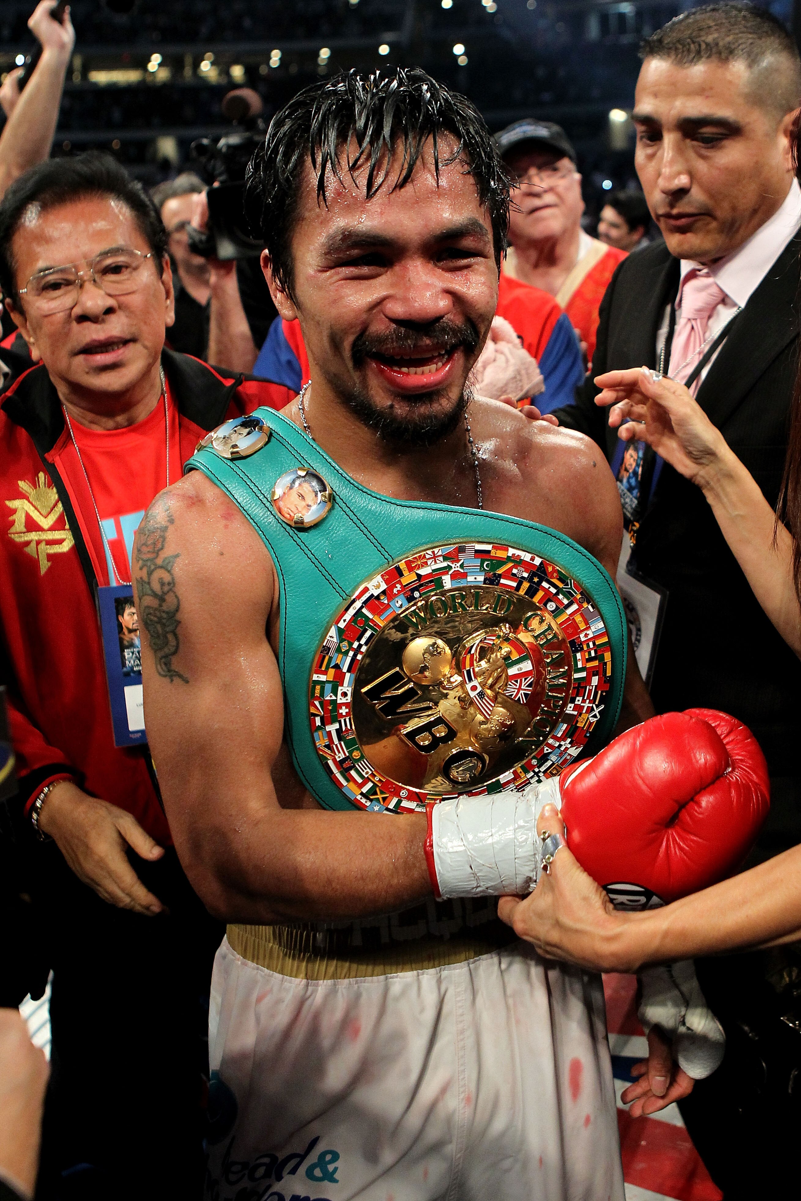 ARLINGTON, TX - NOVEMBER 13:  Manny Pacquiao (white trunks) of the Philippines celebrates after he was declared the winner by a unanimous decision against Antonio Margarito (black trunks) of Mexico during their WBC World Super Welterweight Title bout at C
