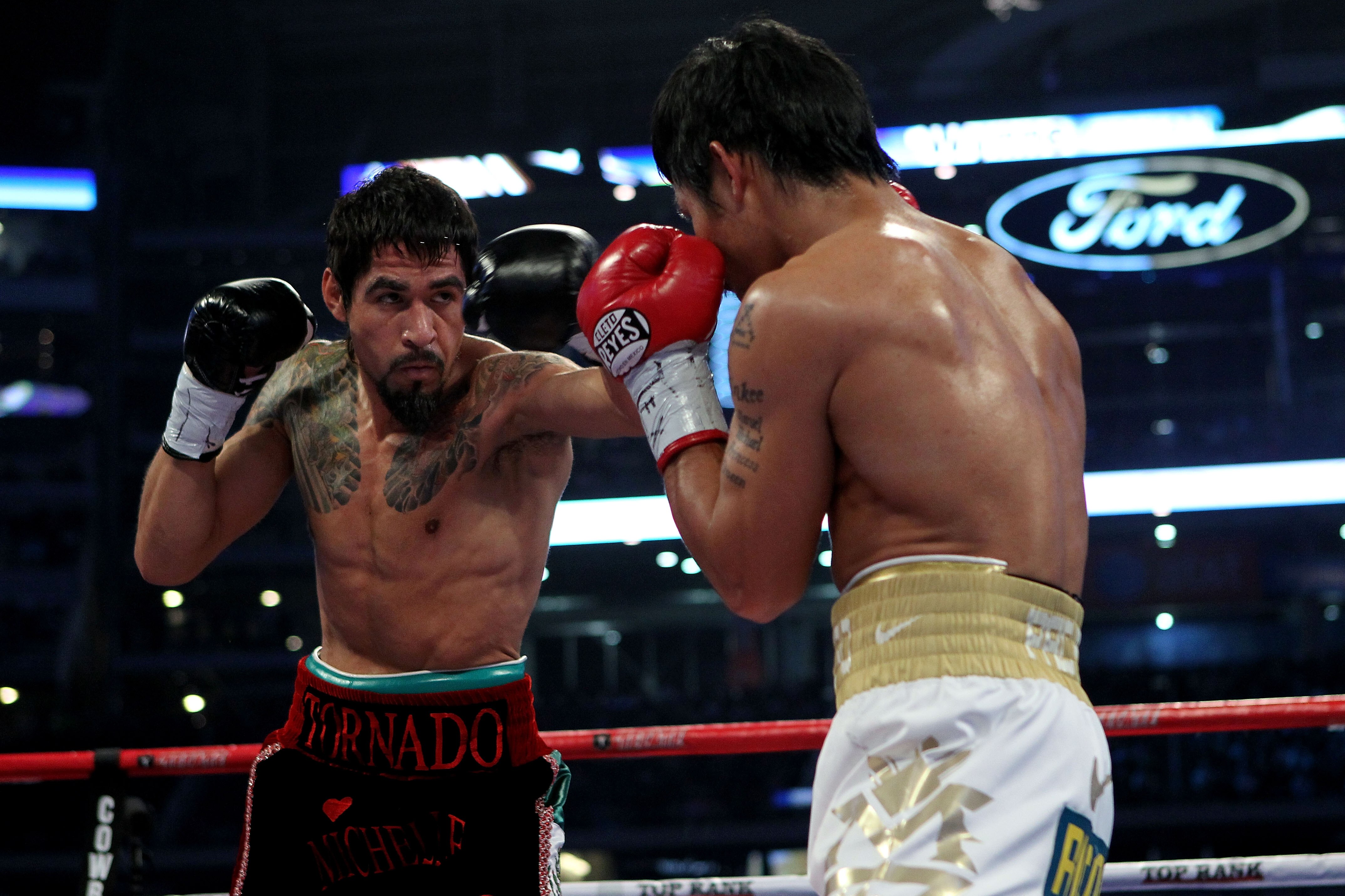 ARLINGTON, TX - NOVEMBER 13:  Antonio Margarito (black trunks) of Mexico throws a punch against Manny Pacquiao (white trunks) of the Philippines during their WBC World Super Welterweight Title bout at Cowboys Stadium on November 13, 2010 in Arlington, Tex