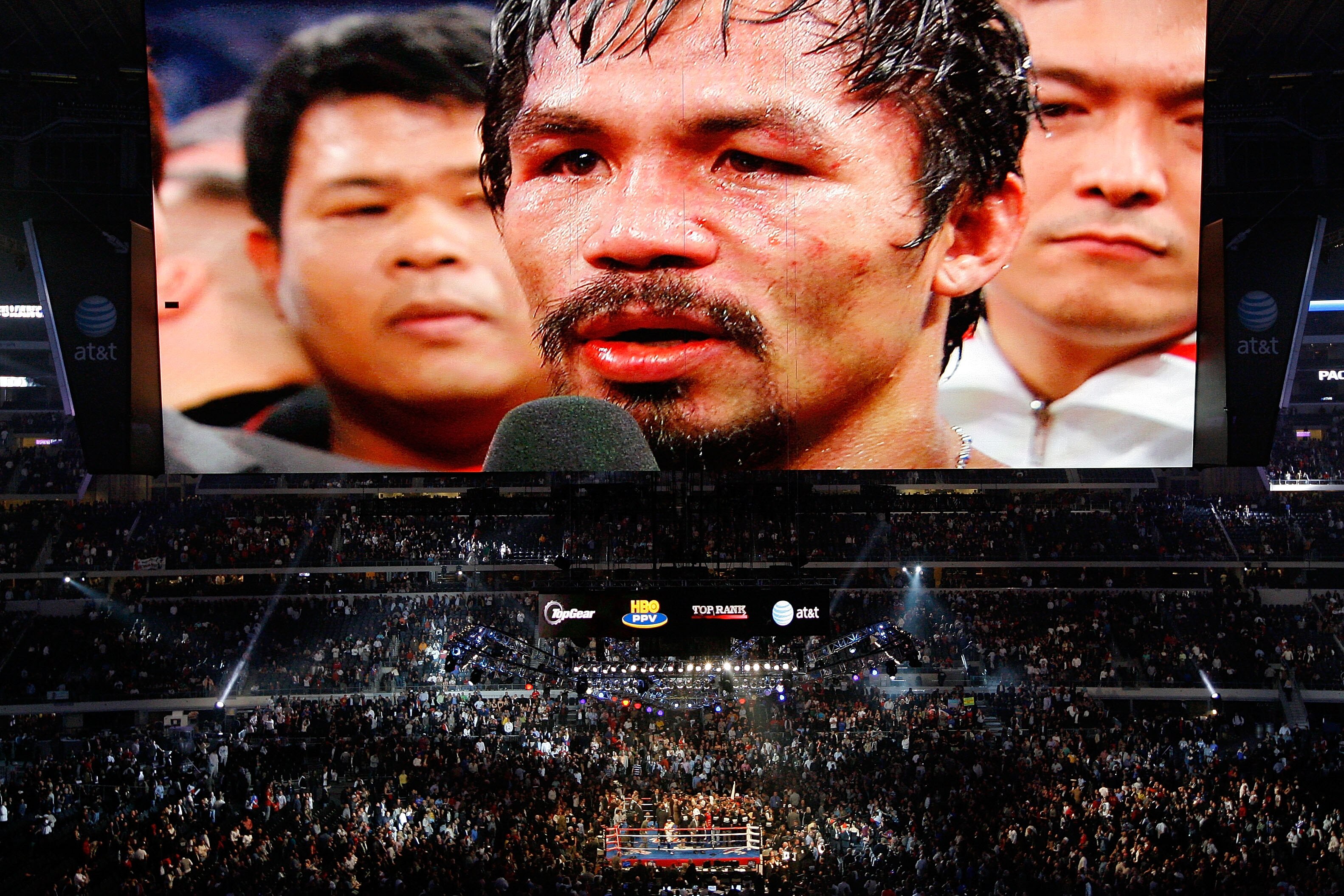 ARLINGTON, TX - NOVEMBER 13:  THe likeness of Manny Pacquiao (white trunks) of the Philippines is seen on the giant screen as he is interviewed after he won against Antonio Margarito (black trunks) of Mexico during their WBC World Super Welterweight Title