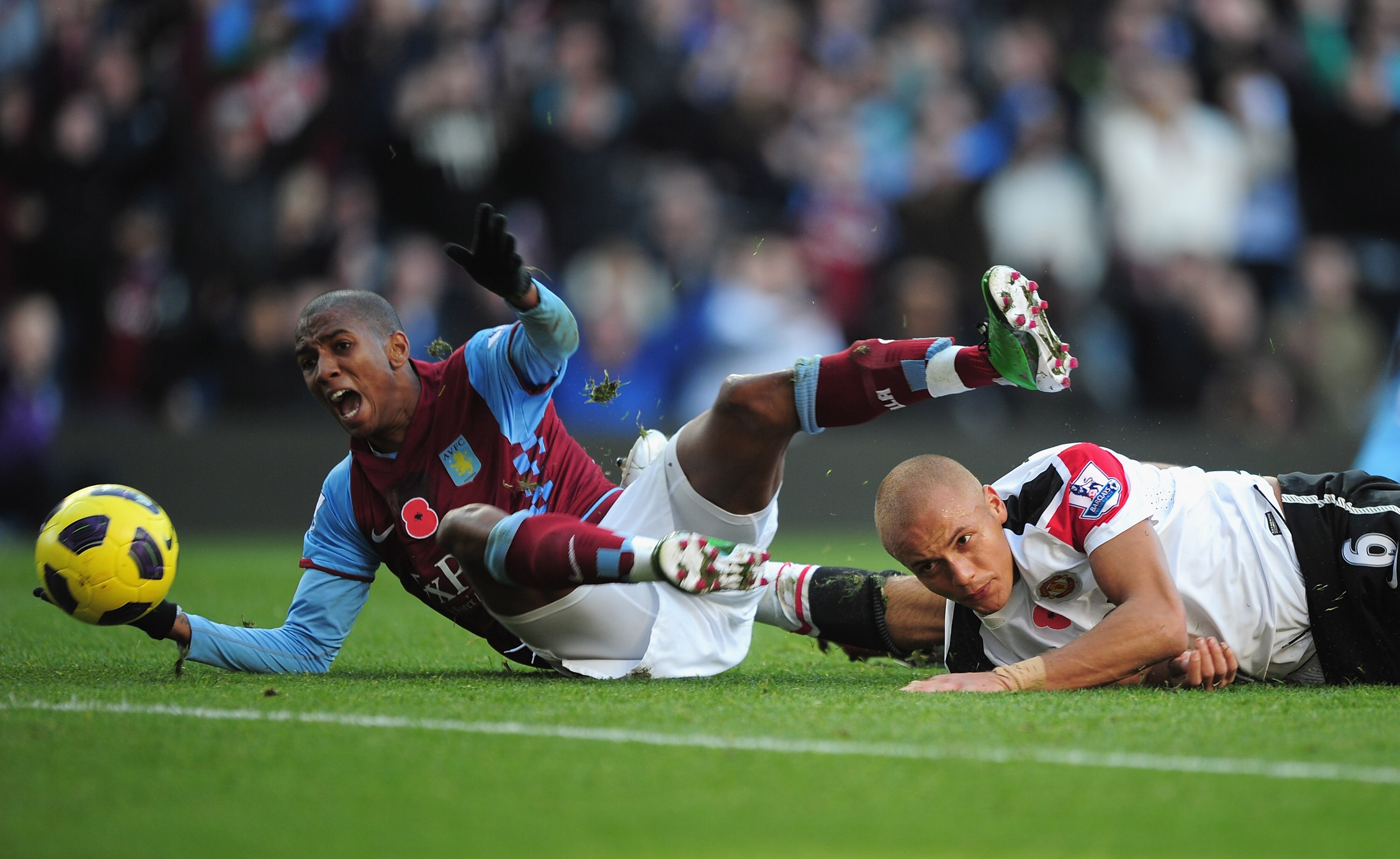 BIRMINGHAM, ENGLAND - NOVEMBER 13:  Ashley Young of Aston Villa is bought down by Wes Brown of Manchester United for a penalty during the Barclays Premier League match between Aston Villa and Manchester United at Villa Park on November 13, 2010 in Birming