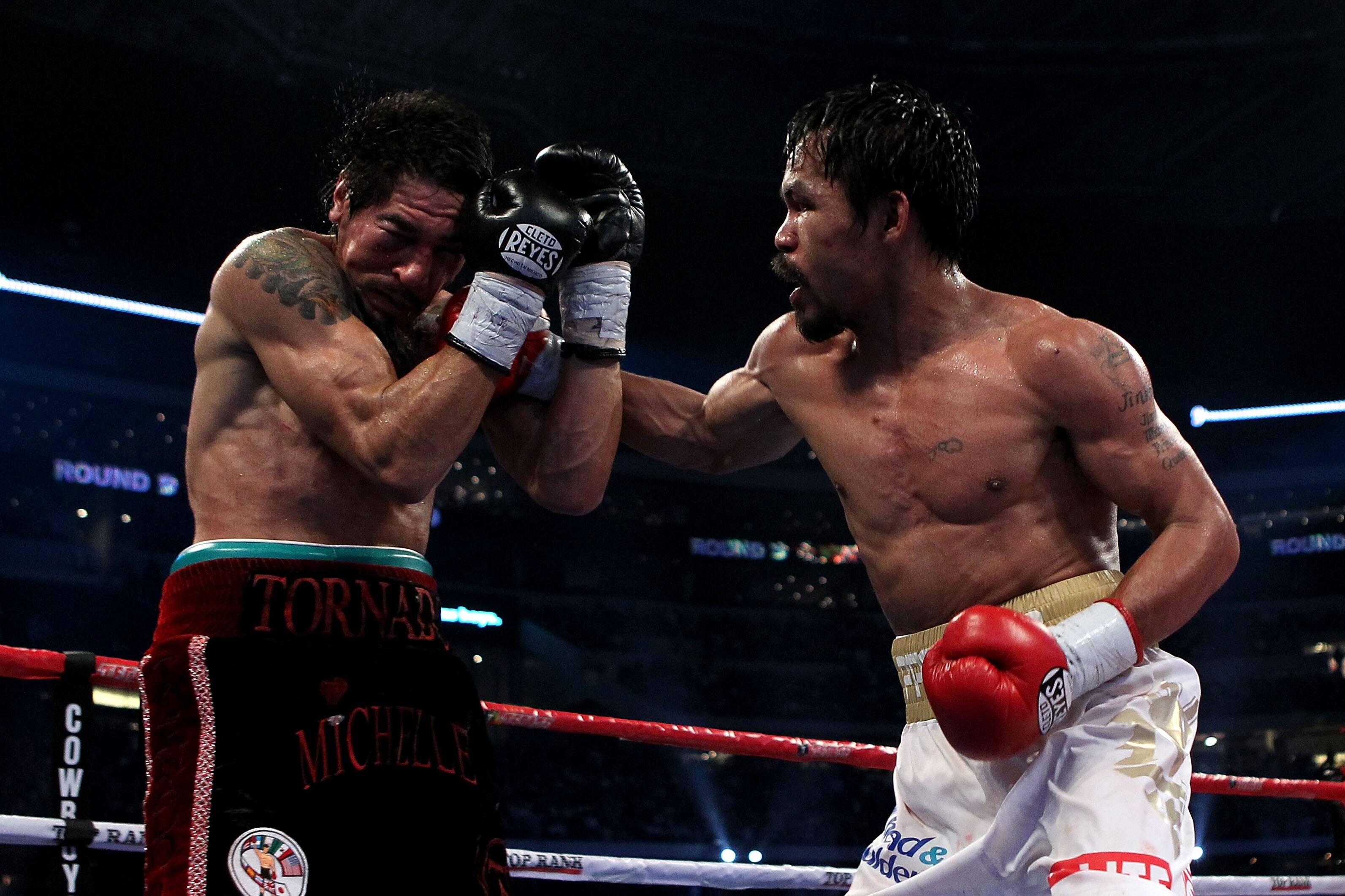 ARLINGTON, TX - NOVEMBER 13:  Manny Pacquiao (white trunks) of the Philippines lands a punch against Antonio Margarito (black trunks) of Mexico during their WBC World Super Welterweight Title bout at Cowboys Stadium on November 13, 2010 in Arlington, Texa