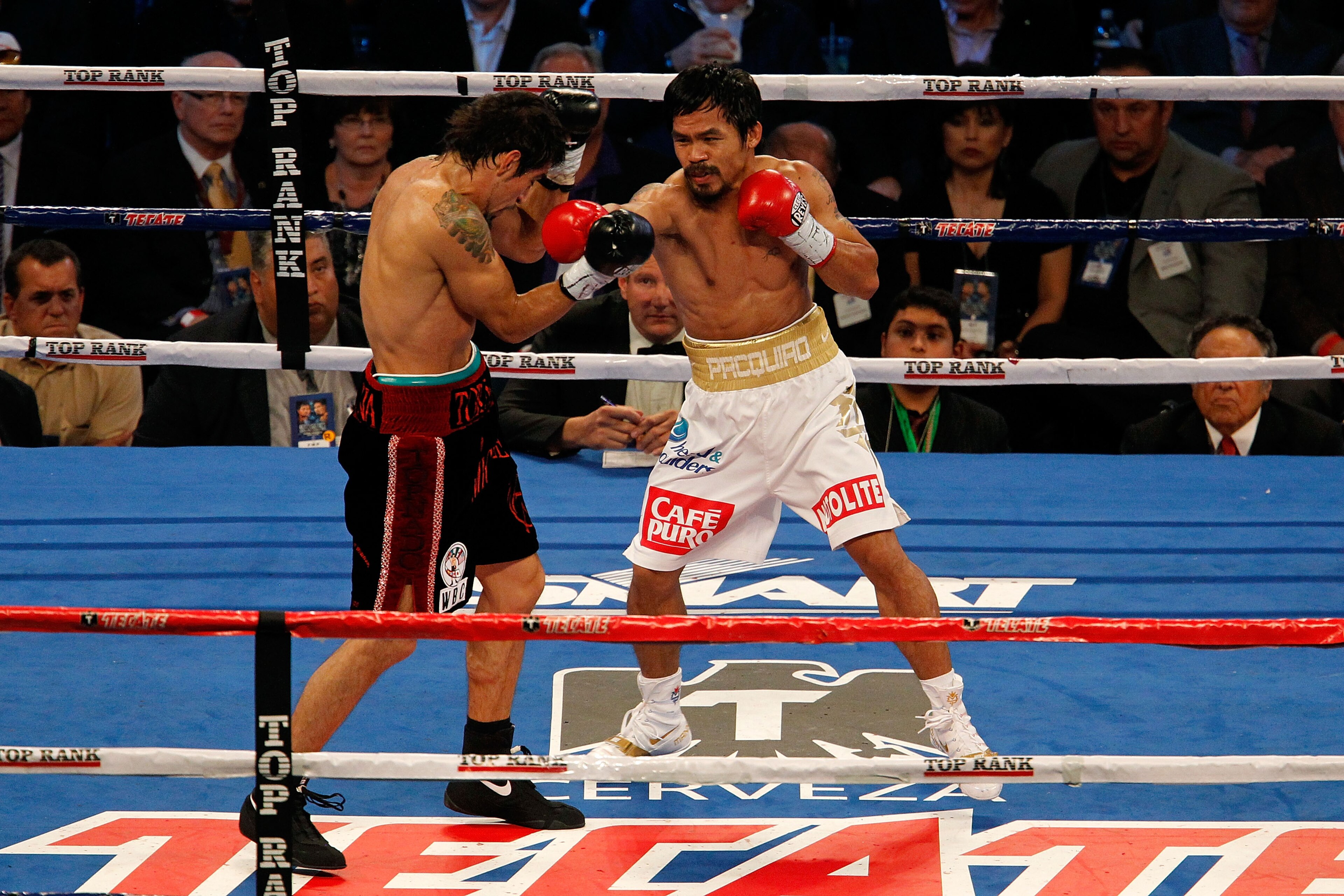 ARLINGTON, TX - NOVEMBER 13:  Manny Pacquiao (white trunks) of the Philippines fights against Antonio Margarito (black trunks) of Mexico during their WBC World Super Welterweight Title bout at Cowboys Stadium on November 13, 2010 in Arlington, Texas.  (Ph