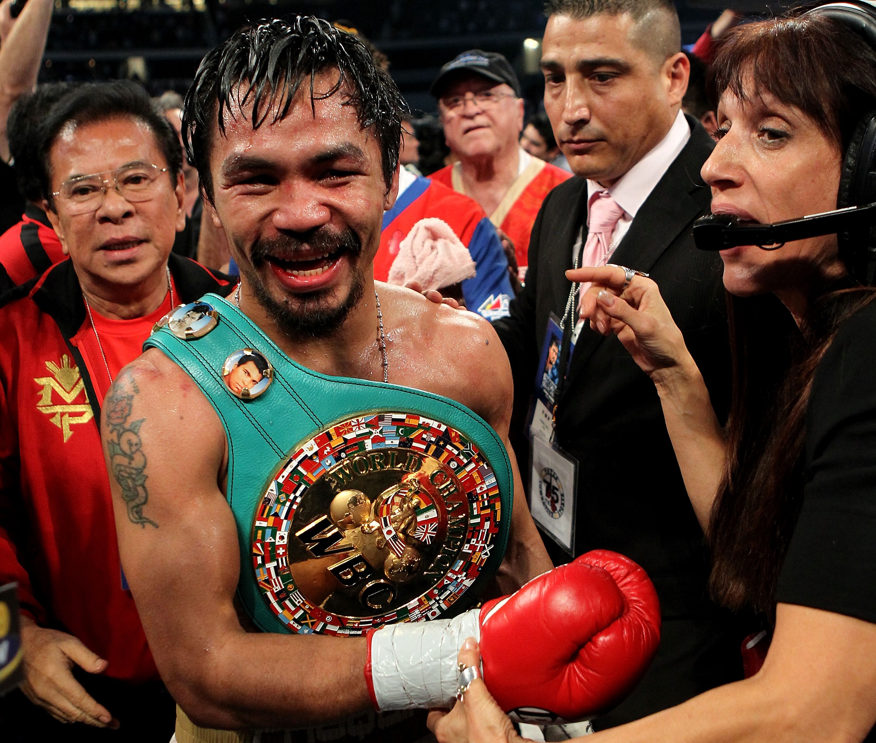 ARLINGTON, TX - NOVEMBER 13:  Manny Pacquiao (white trunks) of the Philippines celebrates after he was declared the winner by a unanimous decision against Antonio Margarito (black trunks) of Mexico during their WBC World Super Welterweight Title bout at C