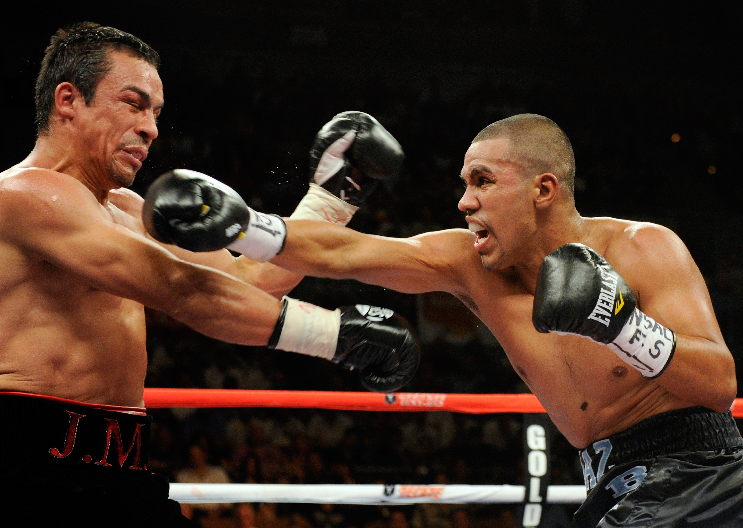 LAS VEGAS - JULY 31:  Juan Diaz  (R) throws a right at WBA/WBO lightweight champion Juan Manuel Marquez in the third round of their bout at the Mandalay Bay Events Center July 31, 2010 in Las Vegas, Nevada. Marquez retained his WBA and WBO lightweight cha