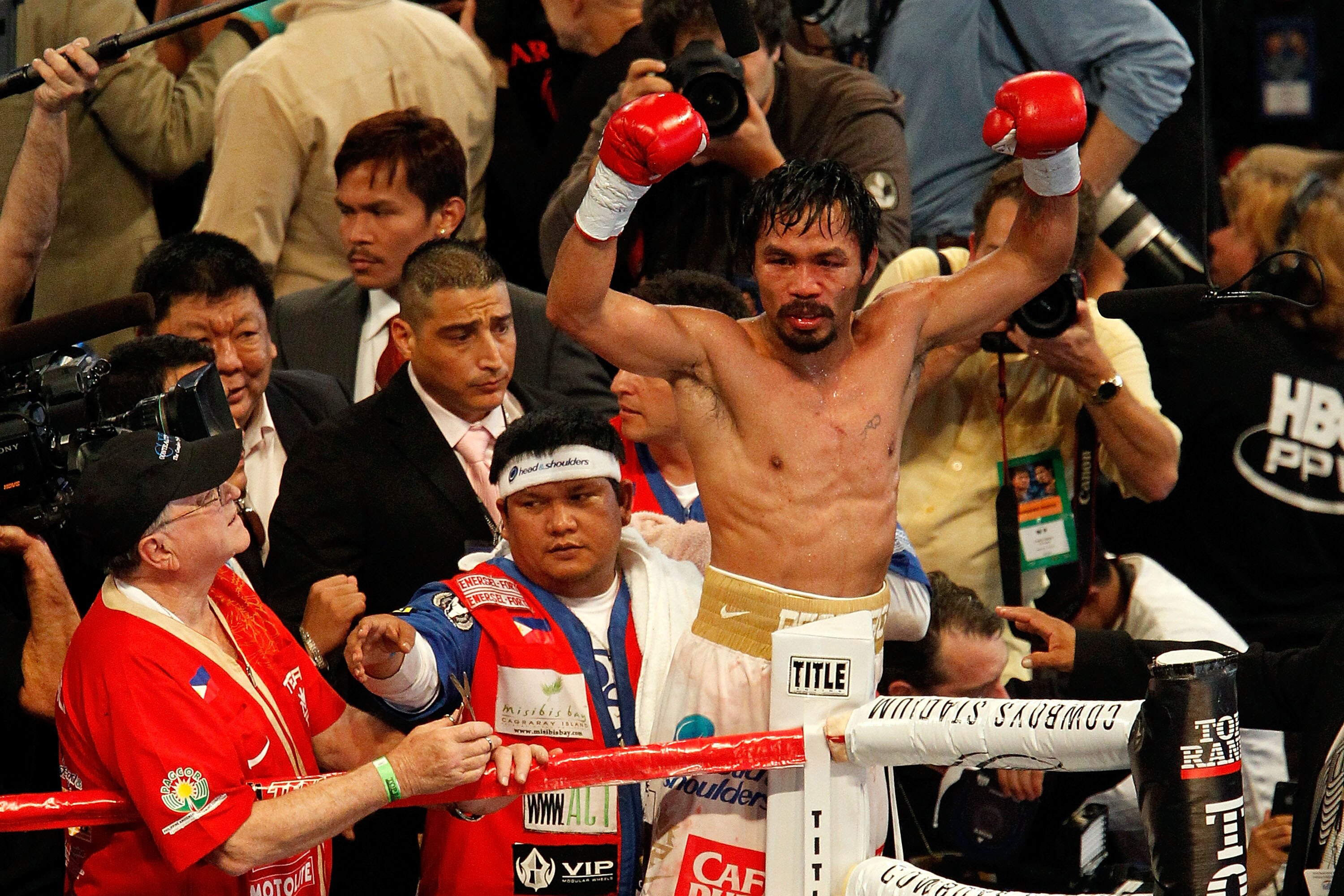 ARLINGTON, TX - NOVEMBER 13:  Manny Pacquiao (white trunks) of the Philippines celebrates after he was declared the winner by a unanimous decision against Antonio Margarito (black trunks) of Mexico during their WBC World Super Welterweight Title bout at C