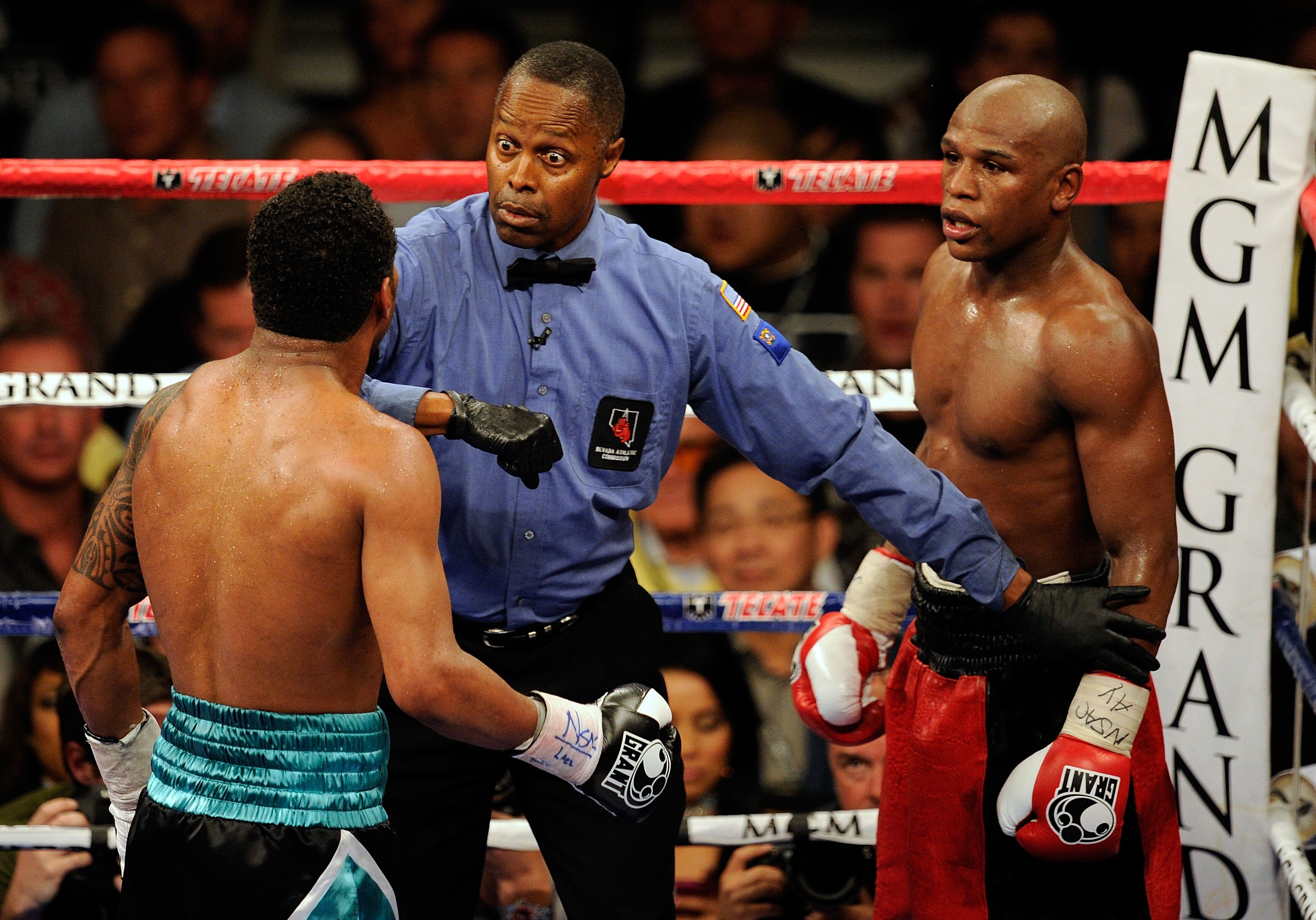LAS VEGAS - MAY 01:  Referee Kenny Bayless looks over at Shane Mosley as he gets between Mosley and Floyd Mayweather Jr. during the welterweight fight at the MGM Grand Garden Arena on May 1, 2010 in Las Vegas, Nevada.  (Photo by Ethan Miller/Getty Images)