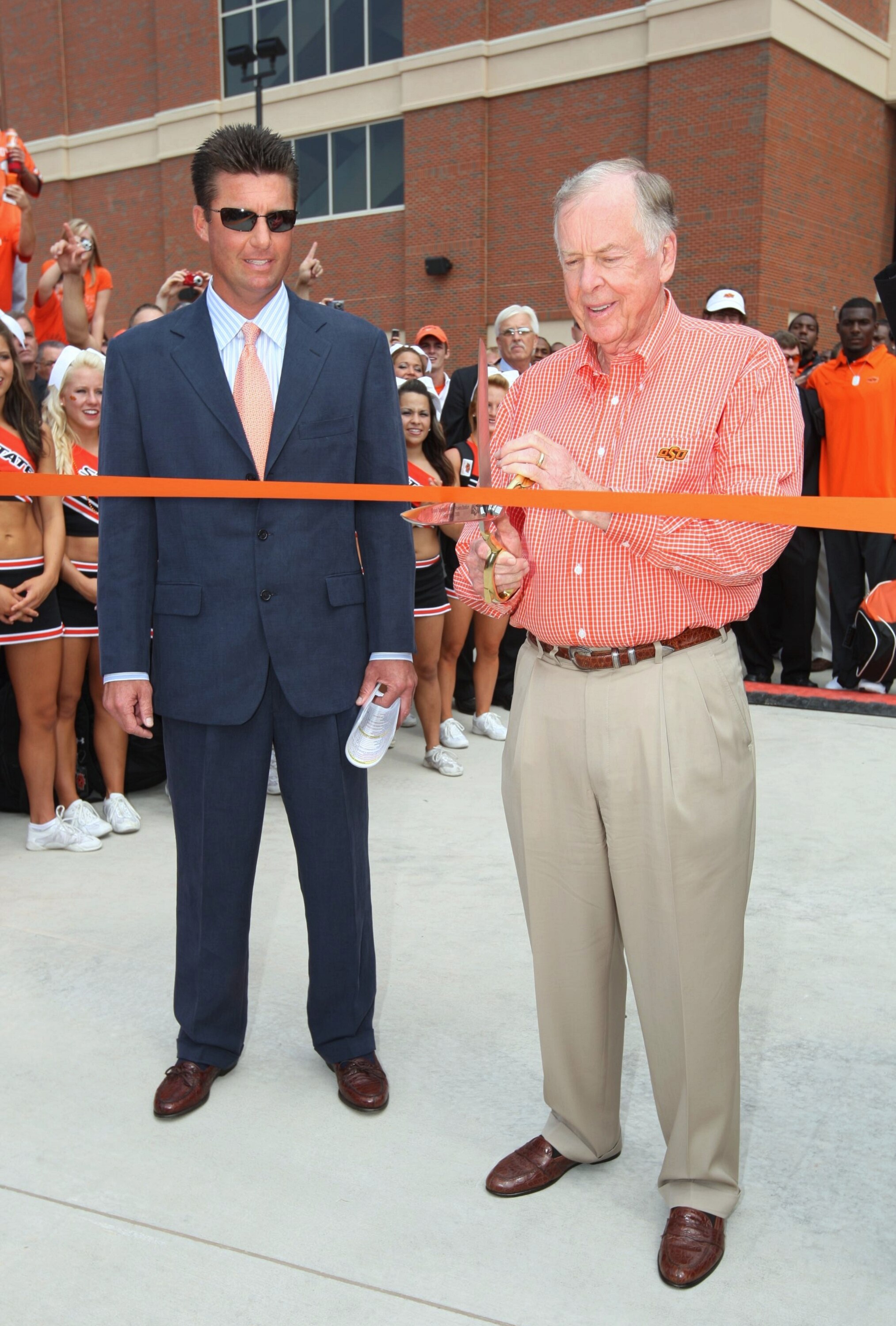 STILLWATER, OK - SEPTEMBER 5:  Boone Pickens cuts the ribbon in next to head coach Mike Gundy of the Oklahoma State Cowboys at the dedication of the Boone Pickens Stadium before the game against the Georgia Bulldogs on September 5, 2009 in Stillwater, Okl