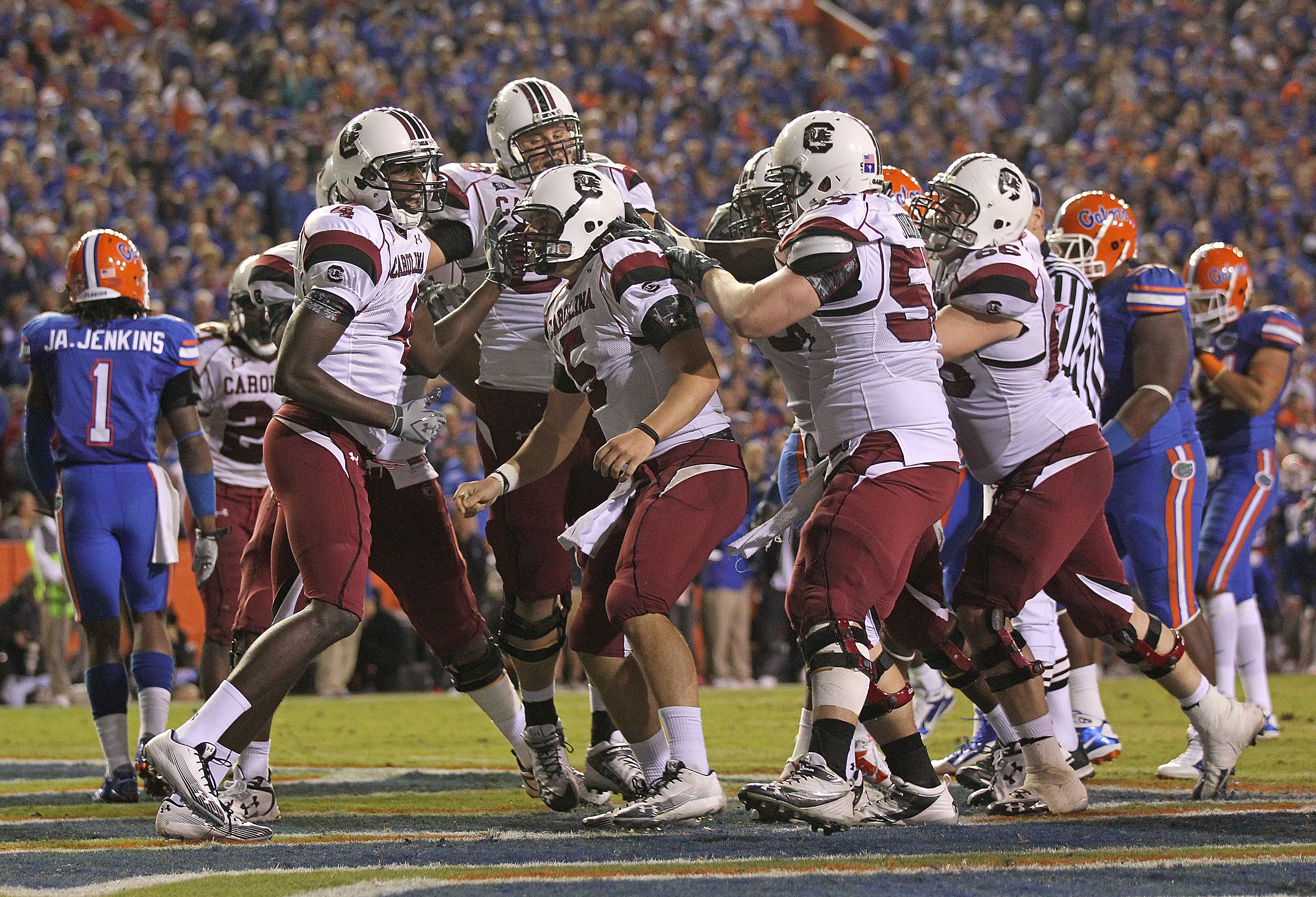 GAINESVILLE, FL - NOVEMBER 13:  Stephen Garcia #5 of the South Carolina Gamecocks is congratulated by teammates after rushing for a touchdown during a game against the Florida Gators at Ben Hill Griffin Stadium on November 13, 2010 in Gainesville, Florida