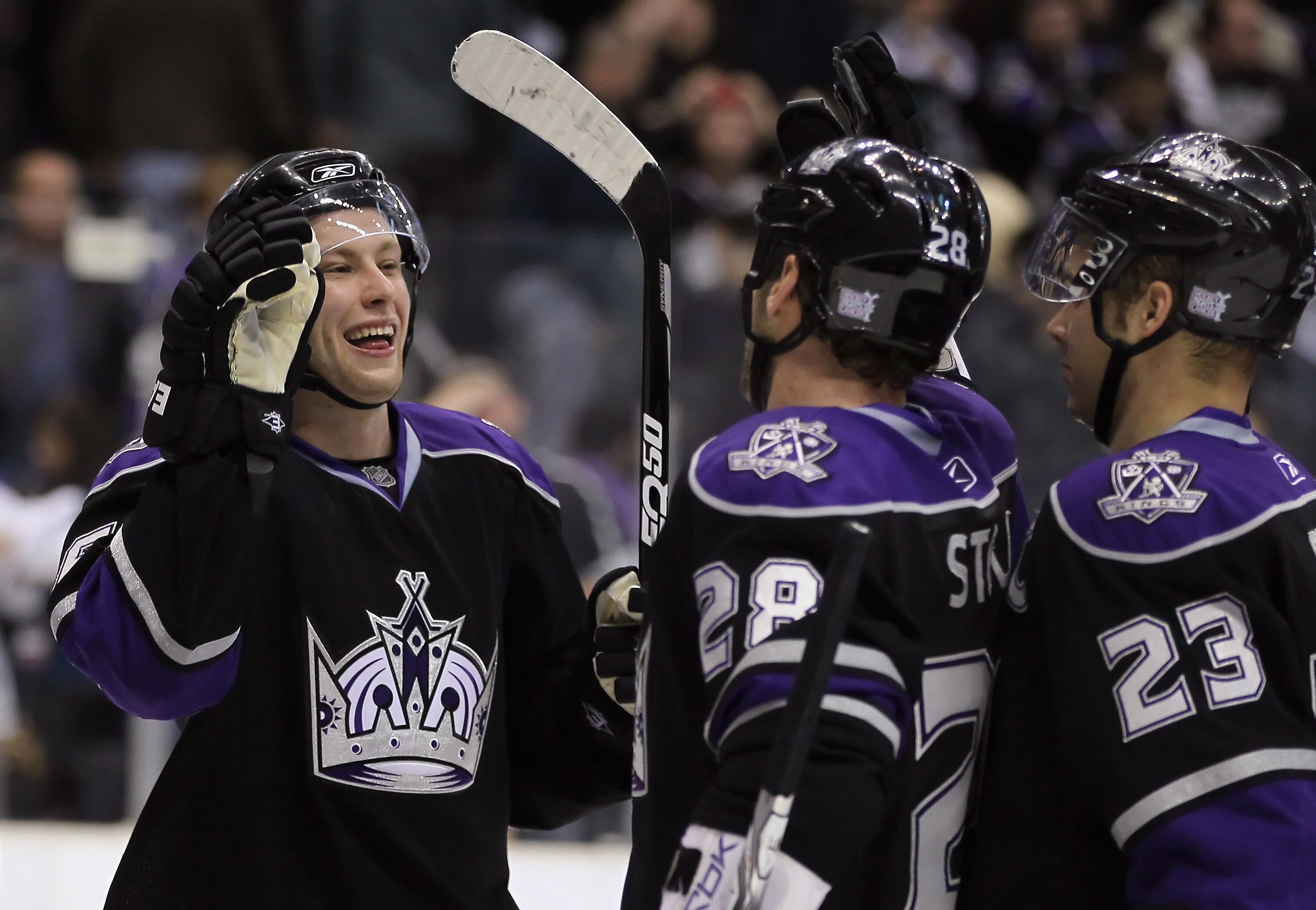 LOS ANGELES, CA - OCTOBER 30:  (L-R) Jake Muzzin #6, Jarret Stoll #28 and Dustin Brown #23 of the Los Angeles Kings celebrate their teams victory over the New Jersey Devils at Staples Center on October 30, 2010 in Los Angeles, California. The Kings defeat