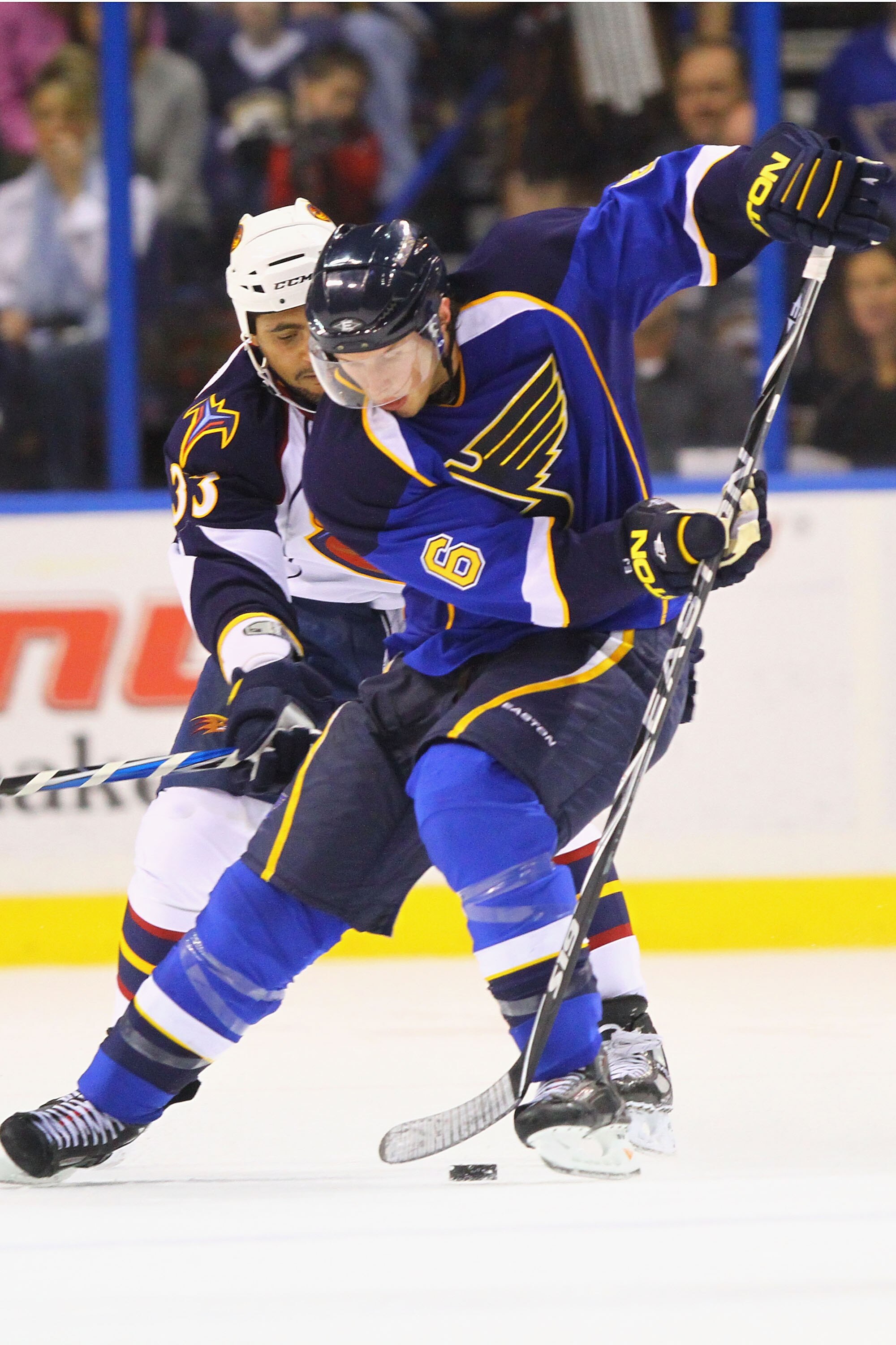 ST. LOUIS - OCTOBER 30: Erik Johnson #6 of the St. Louis Blues controls the puck against Dustin Byfuglien #33 of the Atlanta Thrashers at the Scottrade Center on October 30, 2010 in St. Louis, Missouri.  The Blues beat the Thrashers 4-3 in a shootout.  (P