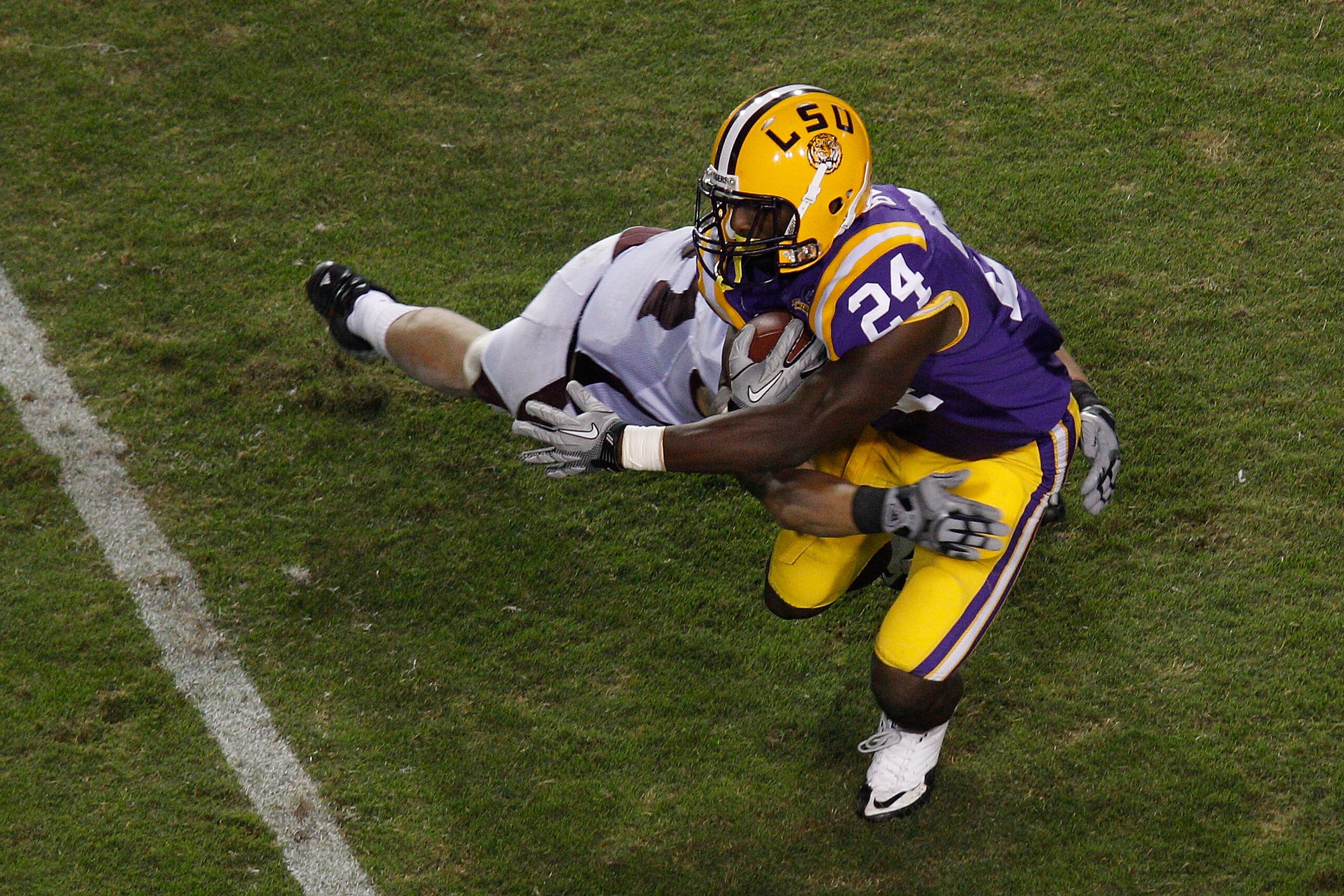 BATON ROUGE, LA - NOVEMBER 13: Alfred Blue #24 of the Louisiana State University Tigers is tackled by Ty Kittle #87 of the University of Louisiana-Monroe Warhawks at Tiger Stadium on November 13, 2010 in Baton Rouge, Louisiana. The Tigers defeated the BATON ROUGE, LA - NOVEMBER 13: Alfred Blue #24 of the Louisiana State University Tigers is tackled by Ty Kittle #87 of the University of Louisiana-Monroe Warhawks at Tiger Stadium on November 13, 2010 in Baton Rouge, Louisiana. The Tigers defeated the