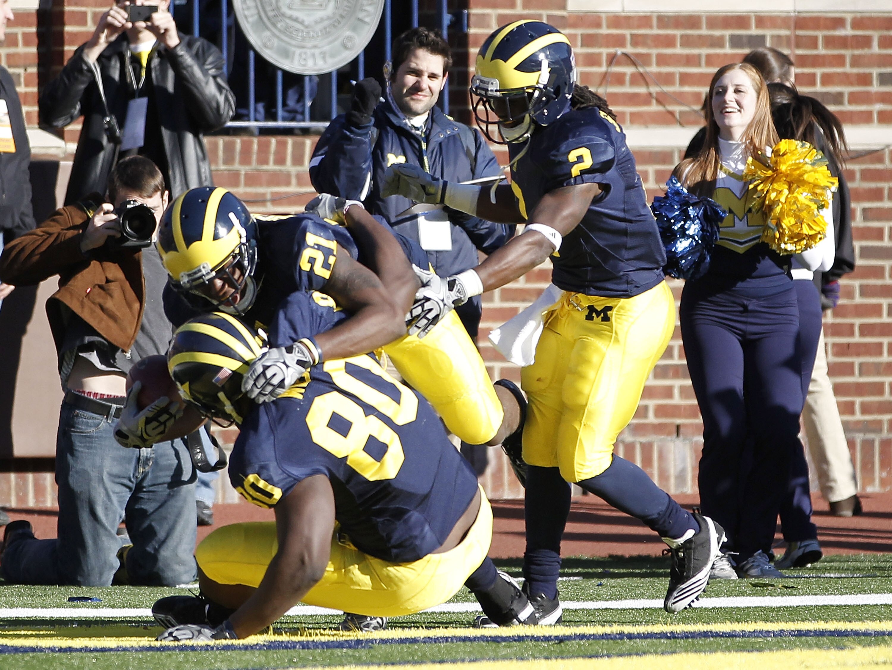 ANN ARBOR, MI - NOVEMBER 06:  Junior Hemingway #21 of the Michigan Wolverines celebrates a two point conversion in triple overtime while playing the Illinios Fighting Illini with Vincent Smith #2 and Martell Webb #80 at Michigan Stadium on November 6, 201