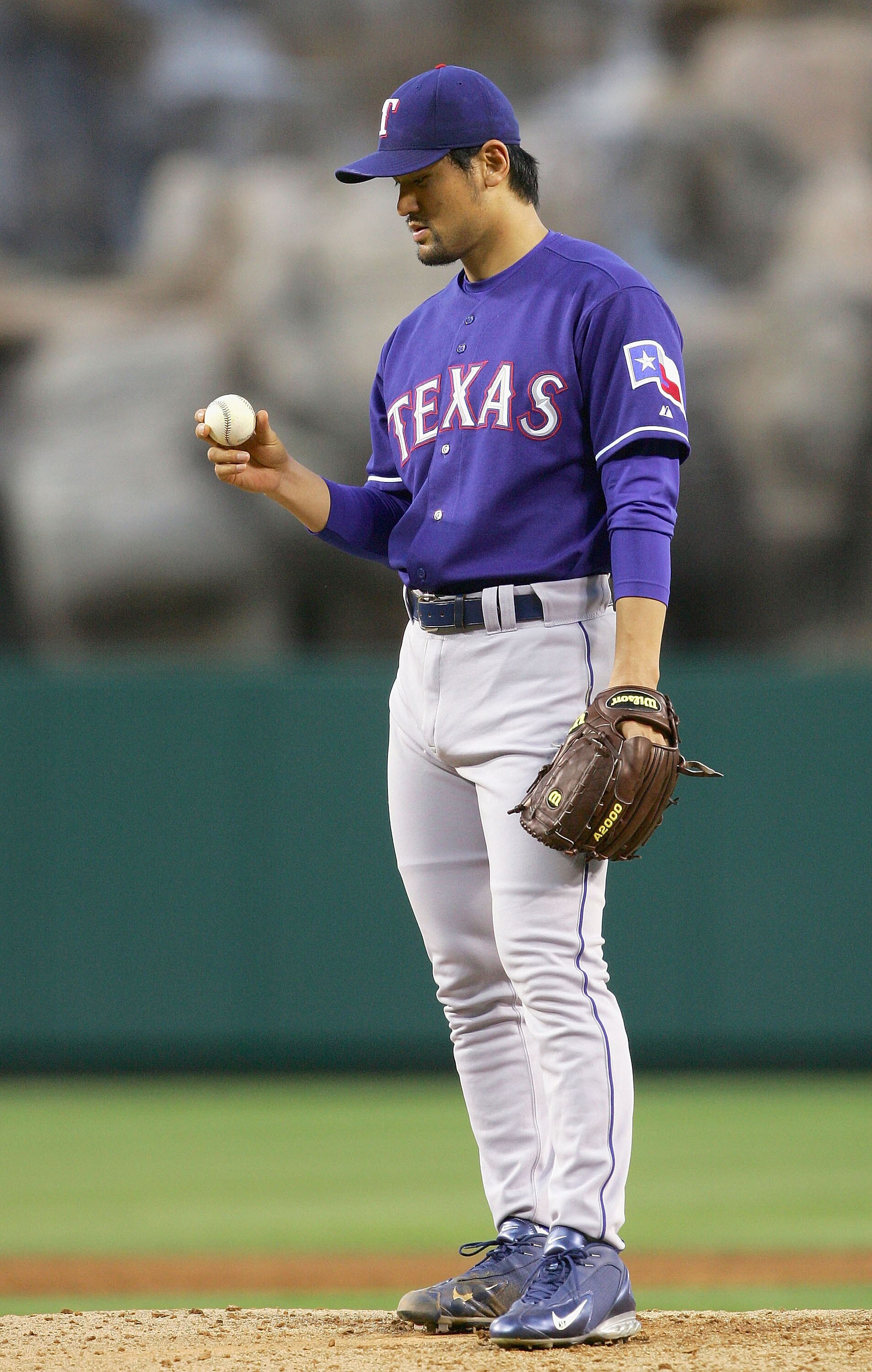 ANAHEIM, CA - JUNE 21:  Starting pitcher Chan Ho Park #61 of the Texas Rangers appears dejected as he is pulled from the game  against the Los Angeles Angels of Anaheim in the second inning after giving up 8 runs on June 21, 2005 at Angel Stadium in Anahe