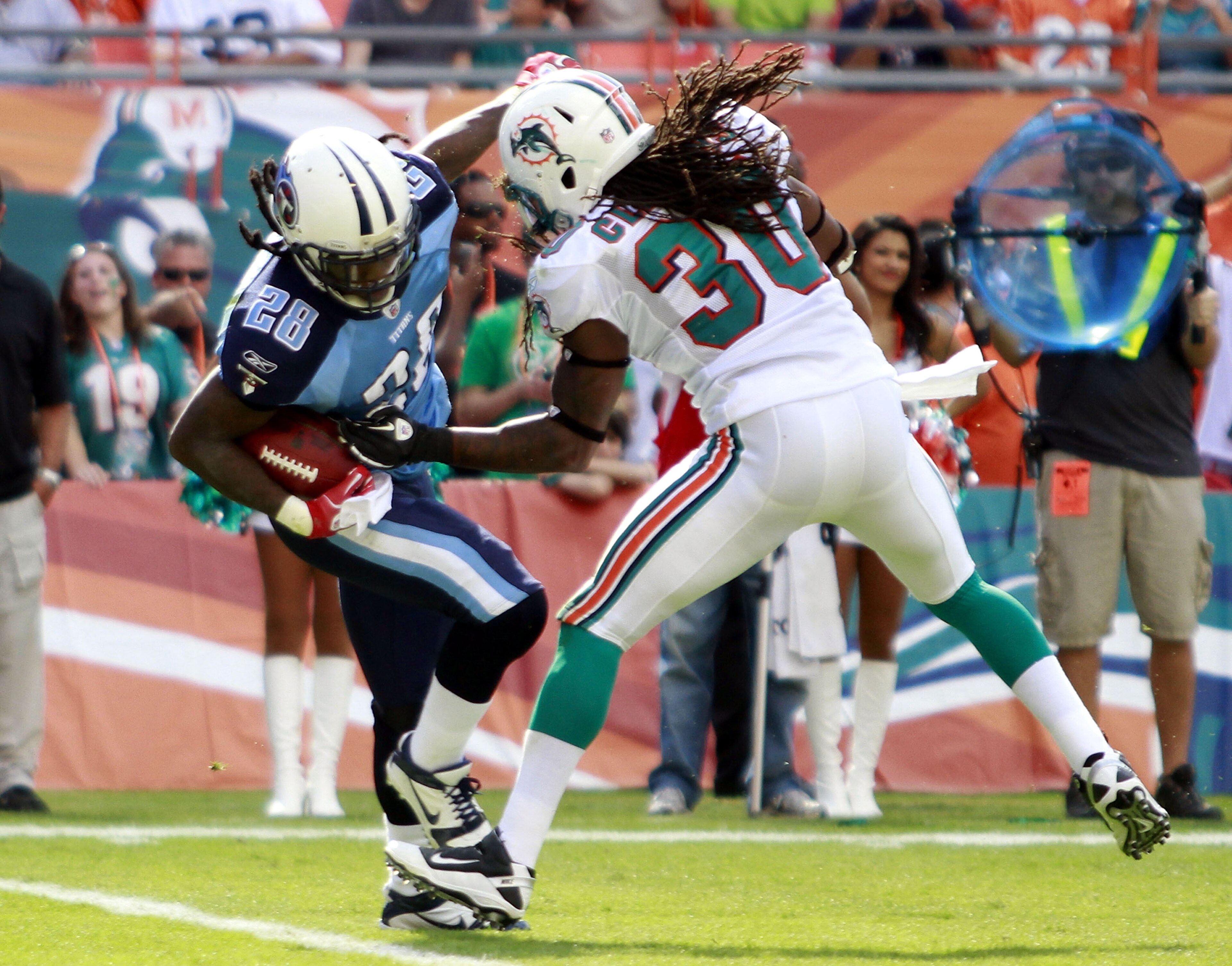 MIAMI - NOVEMBER 14: Running back Chris Johnson #28 of the Tennessee Titans scores a touchdown  against Chris Clemons #30 of the Miami Dolphins at Sun Life Stadium on November 14, 2010 in Miami, Florida.  (Photo by Marc Serota/Getty Images)