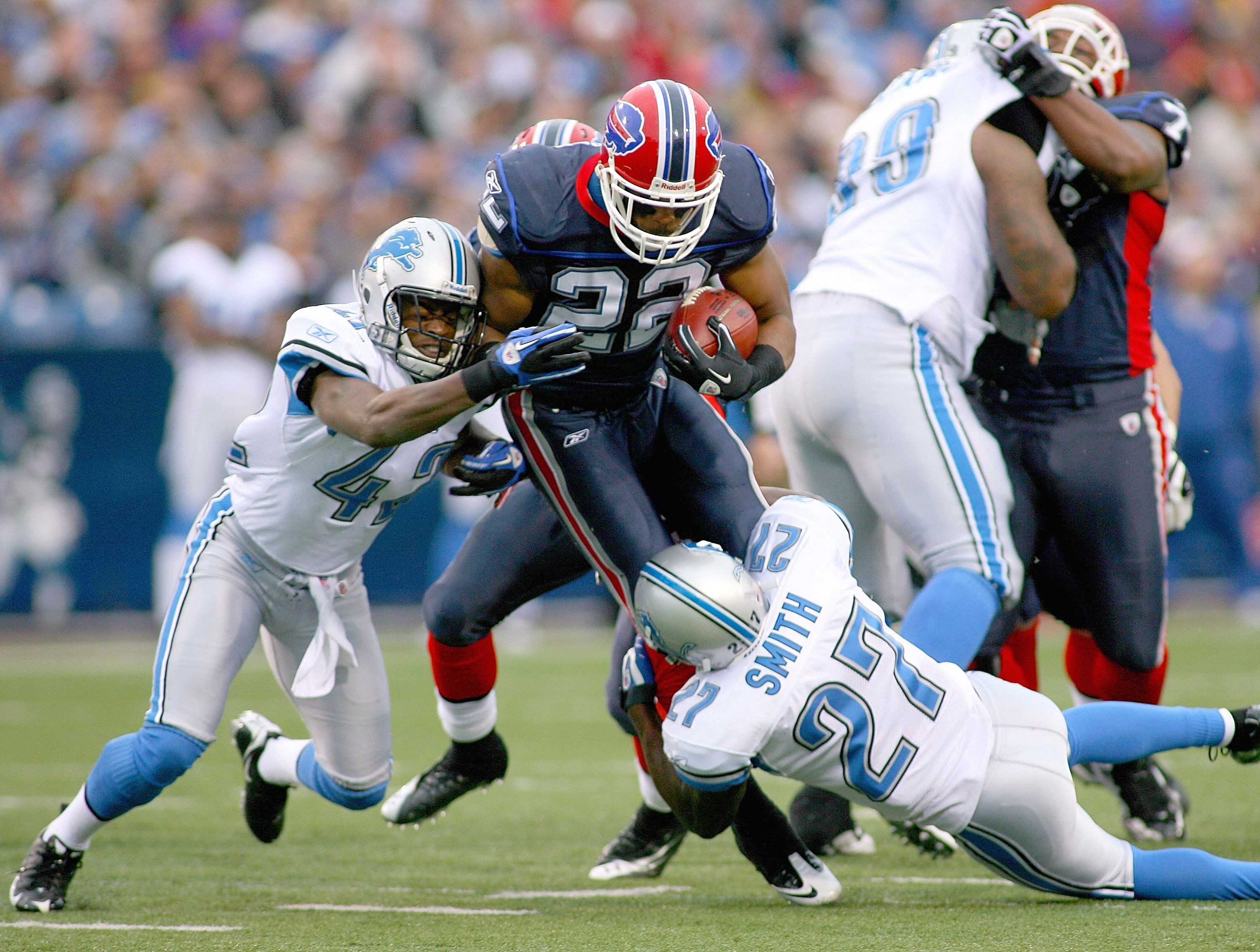 ORCHARD PARK, NY - NOVEMBER 14: Fred Jackson #22 of the Buffalo Bills is tackled by Amari Spivey #42 and Alphonso Smith #27 of the Detroit Lions at Ralph Wilson Stadium on November 14, 2010 in Orchard Park, New York.  (Photo by Rick Stewart/Getty Images)