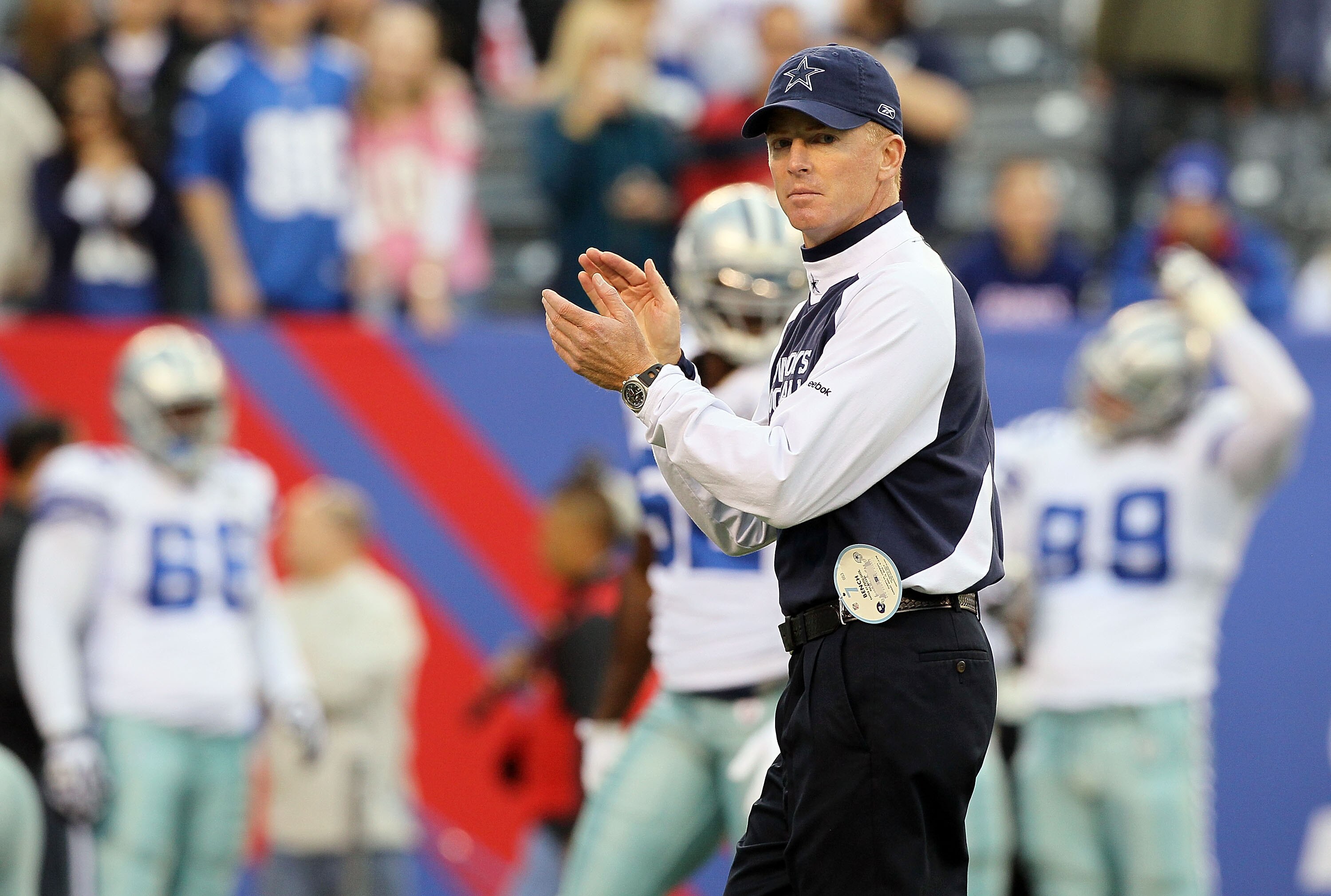 EAST RUTHERFORD, NJ - NOVEMBER 14:  Head coach Jason Garrett of the Dallas Cowboys works  with his team as they warm up prior to playing against the New York Giants on November 14, 2010 at the New Meadowlands Stadium in East Rutherford, New Jersey.  (Phot