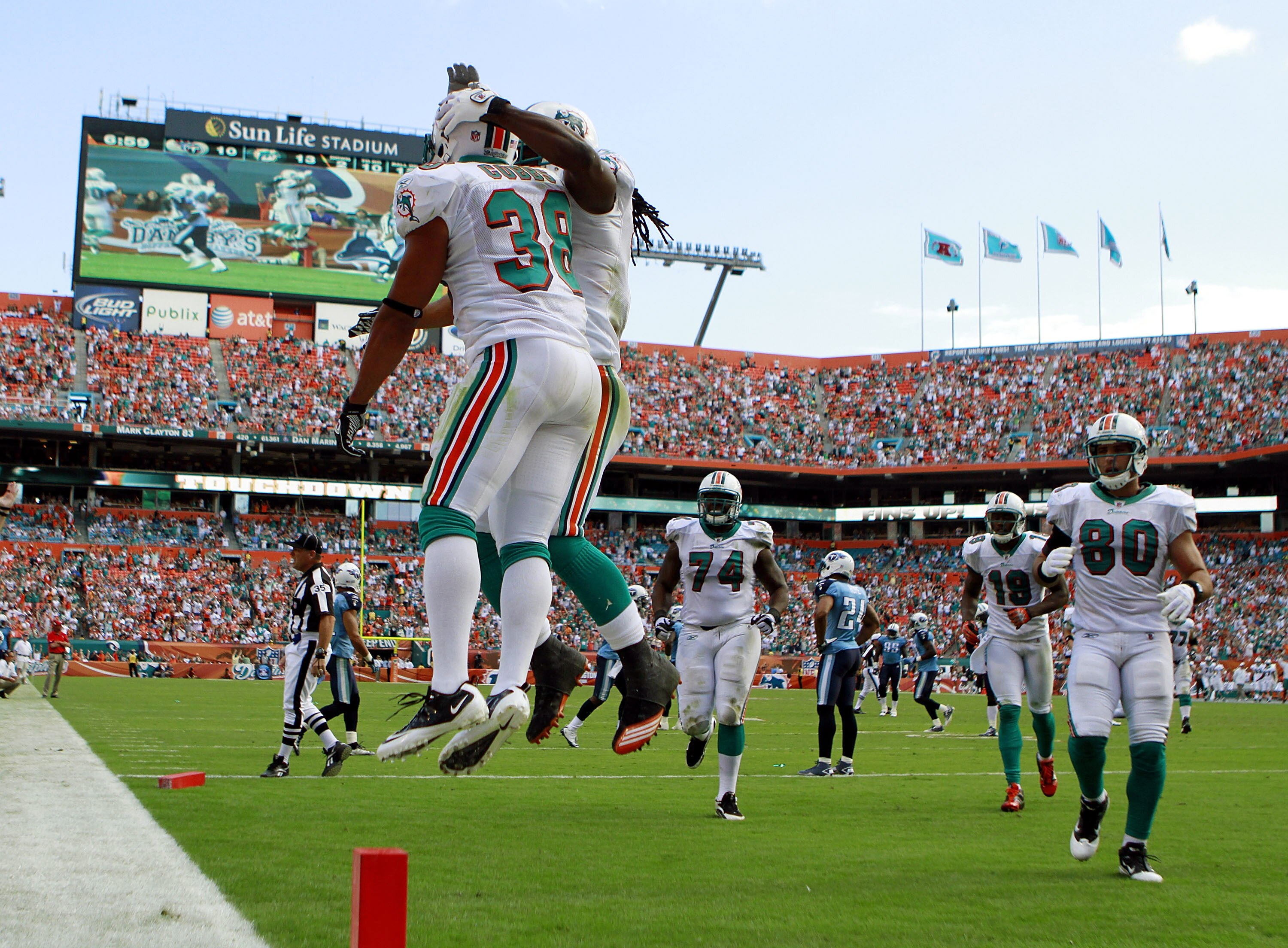 MIAMI - NOVEMBER 14:  Patrick Cobb #38 (L) of the Miami Dolphins celebrates a touchdown against the Tennessee Titans at Sun Life Stadium on November 14, 2010 in Miami, Florida.  (Photo by Marc Serota/Getty Images)