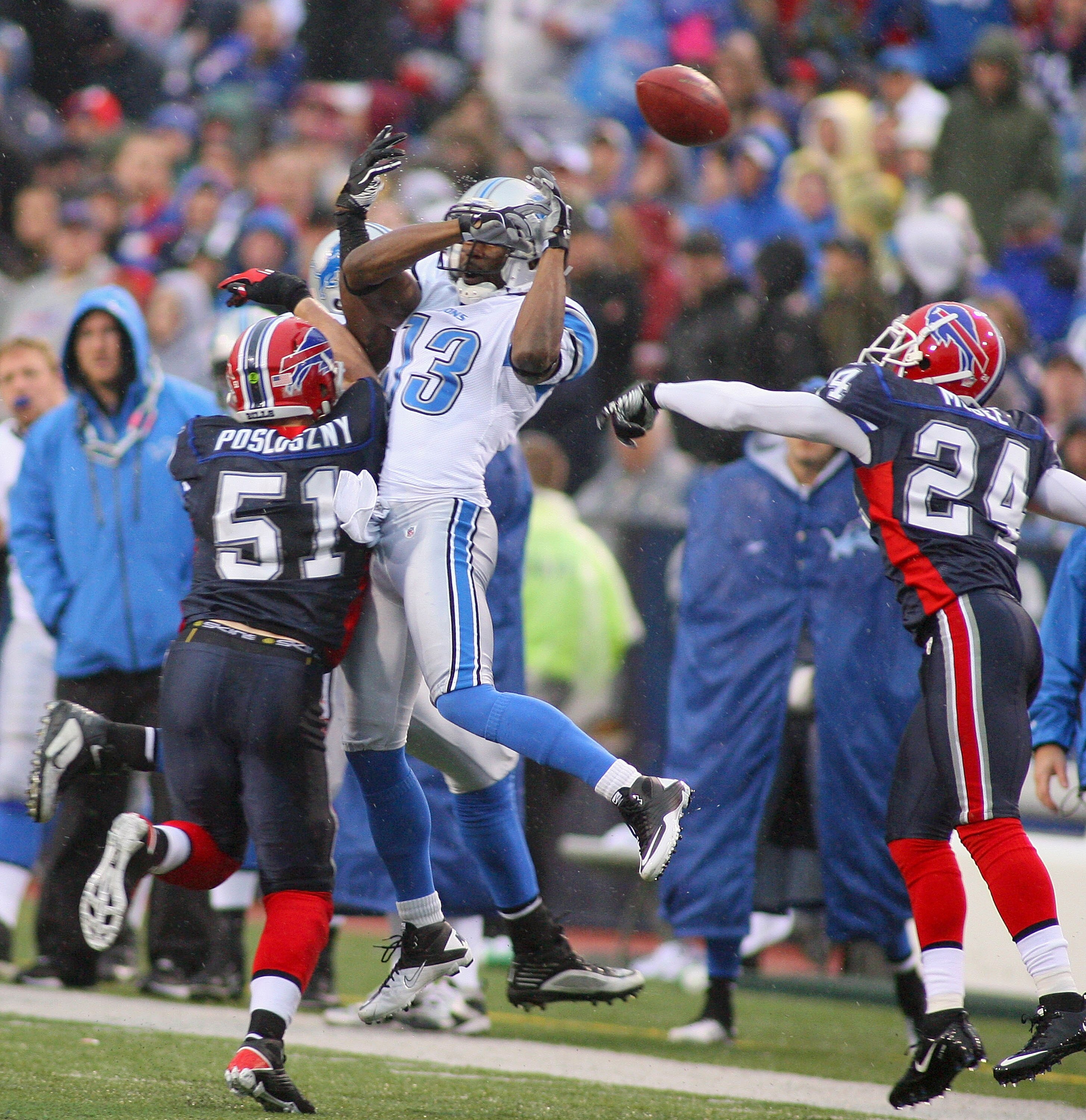 ORCHARD PARK, NY - NOVEMBER 14: Nate Burleson #13 of the Detroit Lions has the ball bounce off his hands as Paul Posluszny #51 and Terrence McGee #24 of the Buffalo Bills defend at Ralph Wilson Stadium on November 14, 2010 in Orchard Park, New York. Buffa