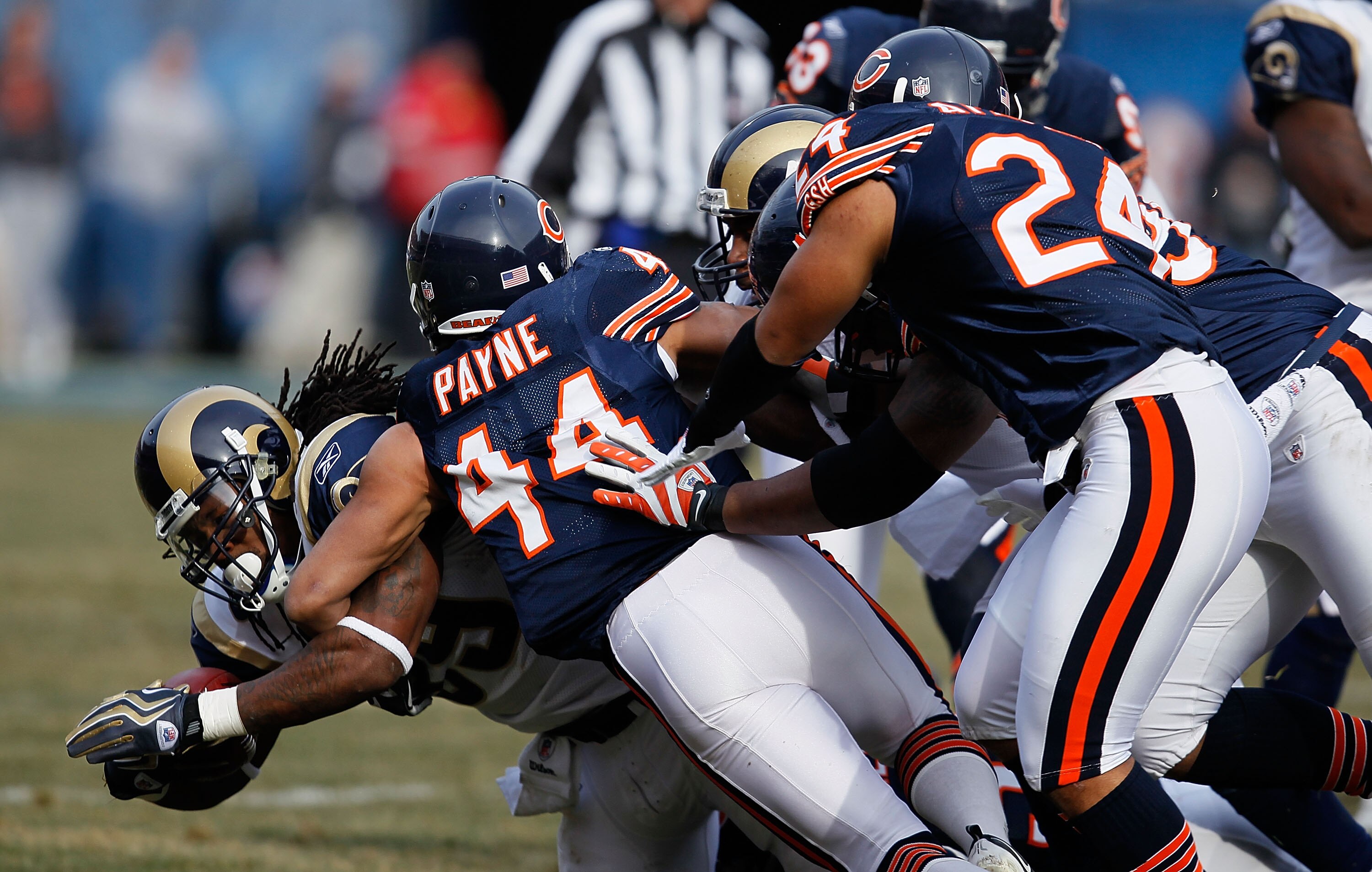 CHICAGO - DECEMBER 06: Members of the Chicago Bear defense including Kevin Payne #44 and Al Afalava #24 gang-tackle Steven Jackson #39 of the St. Louis Rams at Soldier Field on December 6, 2009 in Chicago, Illinois. (Photo by Jonathan Daniel/Getty Images)