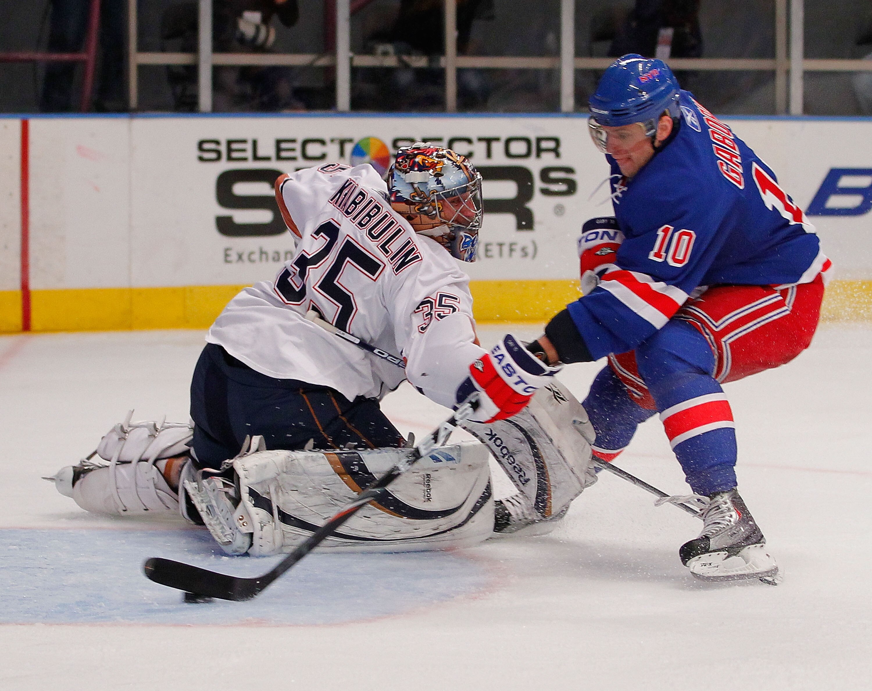 NEW YORK - NOVEMBER 14:  Goalie Nikolai Khabibulin #35 of the Edmonton Oilers is faked out of position by Marian Gaborik #10 of the New York Rangers who scores on this breakaway during the second period of a hockey game at Madison Square Garden on Novembe