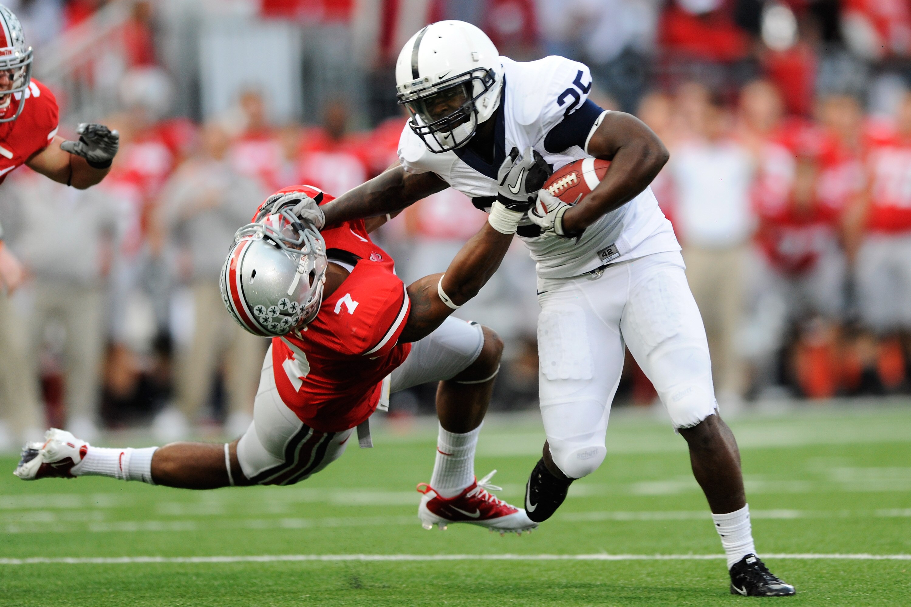 COLUMBUS, OH - NOVEMBER 13:  Silas Redd #25 of the Penn State Nittany Lions stiff arms Jermale Hines #7 of the Ohio State Buckeyes at Ohio Stadium on November 13, 2010 in Columbus, Ohio.  (Photo by Jamie Sabau/Getty Images)