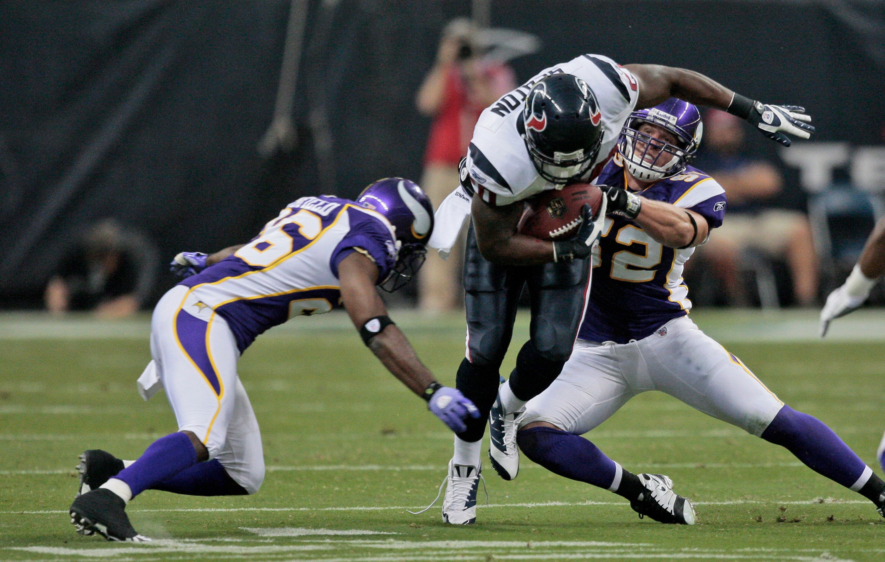 HOUSTON - AUGUST 31:  Running back Steve Slaton #20 of the Houston Texans runs through the tackle of linebackers  Chad Greenway #52 and E.J. Henderson #56 of the Minnesota Vikings at Reliant Stadium on August 31, 2009 in Houston, Texas.  (Photo by Bob Lev