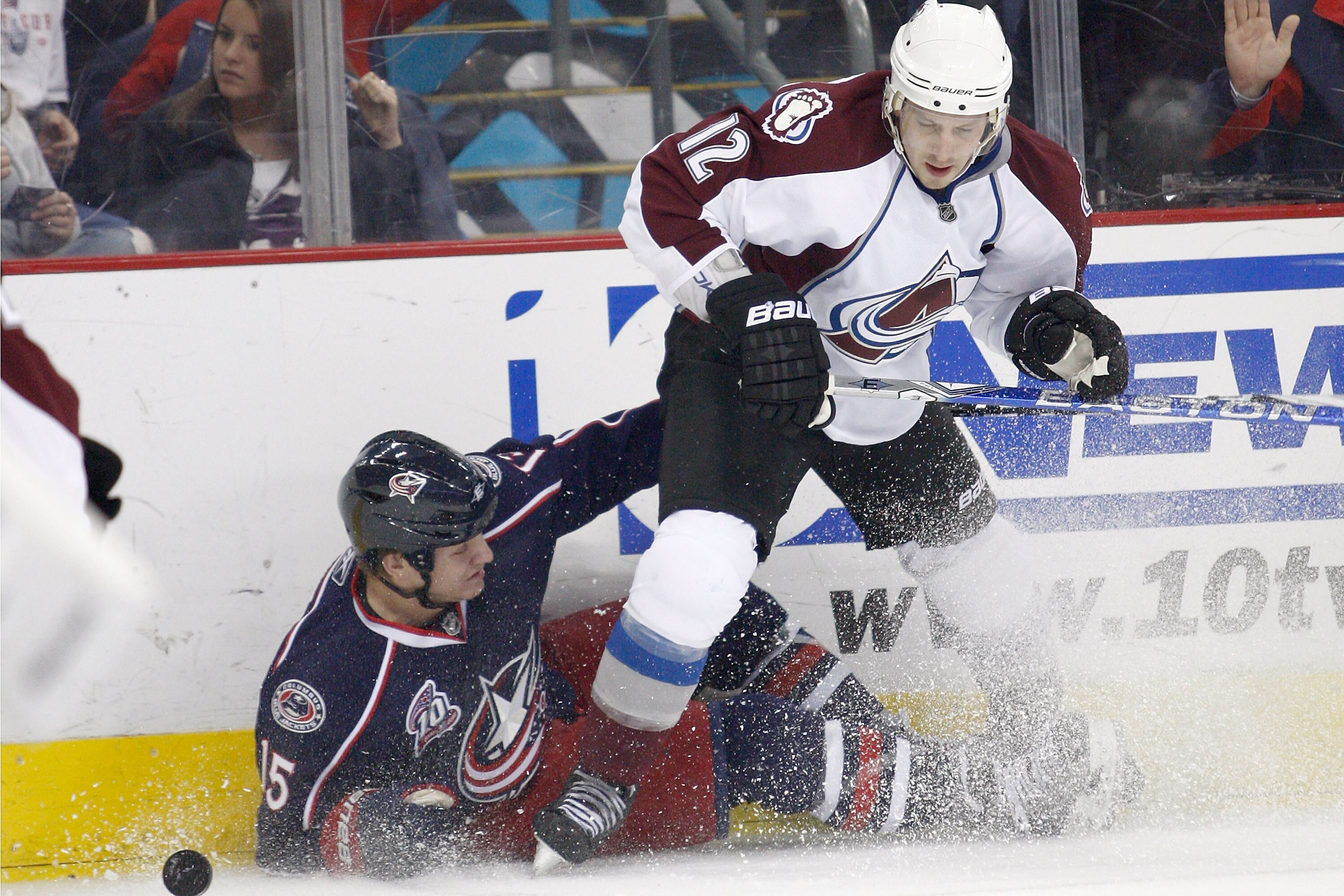 COLUMBUS,OH - NOVEMBER 12:  Kevin Porter #12 of the Colorado Avalanche checks Derek Dorsett #15 of the Columbus Blue Jackets to the ice while chasing after a loose puck during the second period on November 12, 2010 at Nationwide Arena in Columbus, Ohio.  
